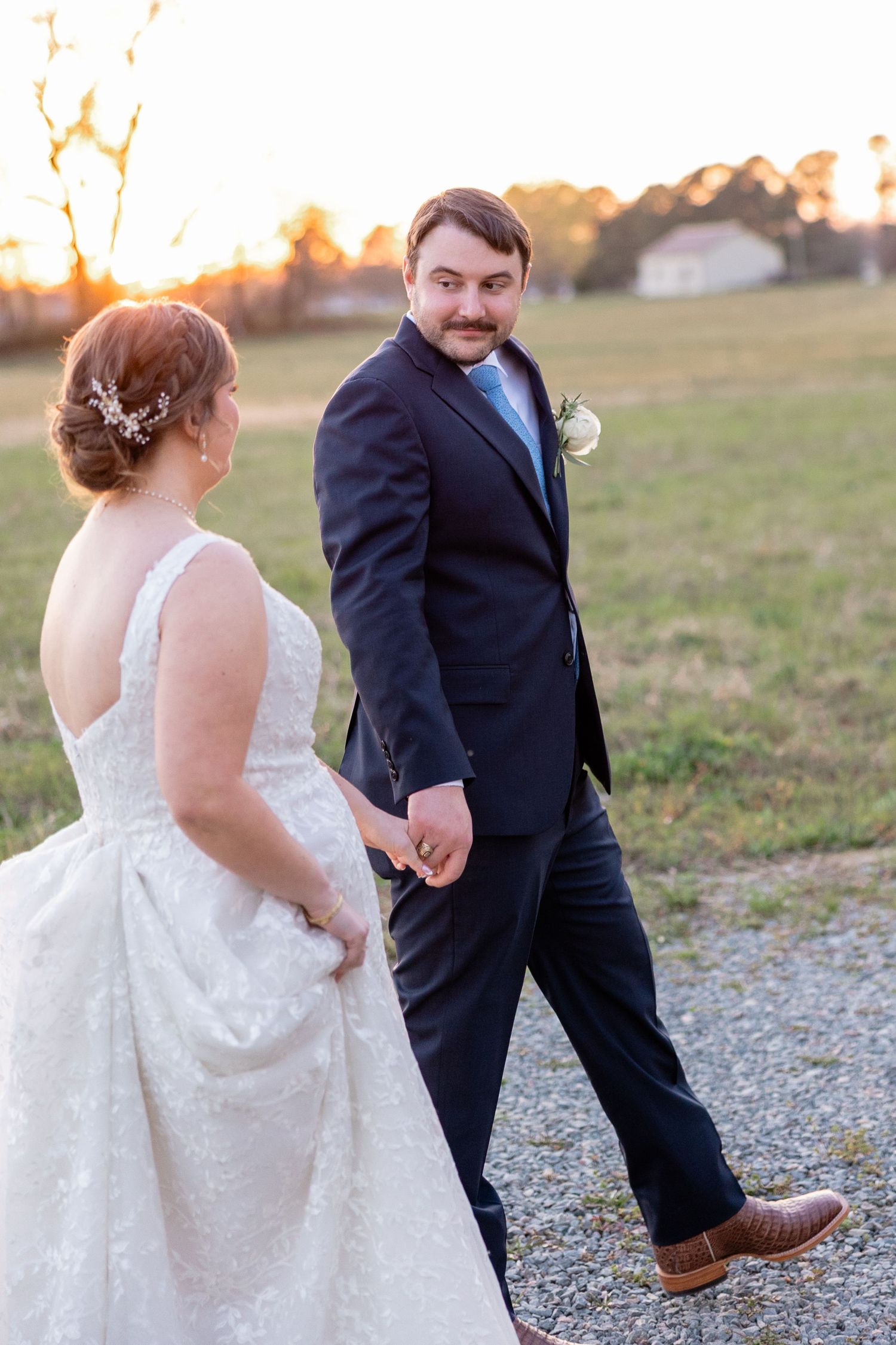 Candid wedding photos on a gravel path at sunset showing playful moments and laughter.