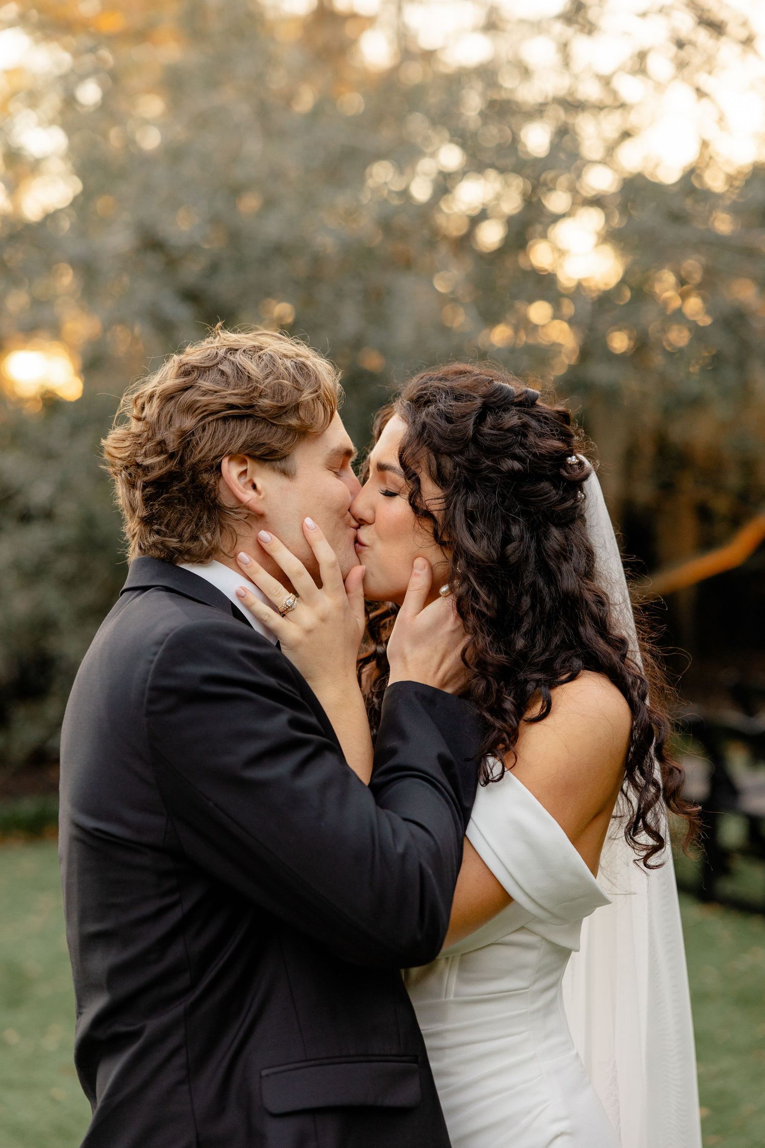A romantic wedding moment captured at sunset in a garden setting.