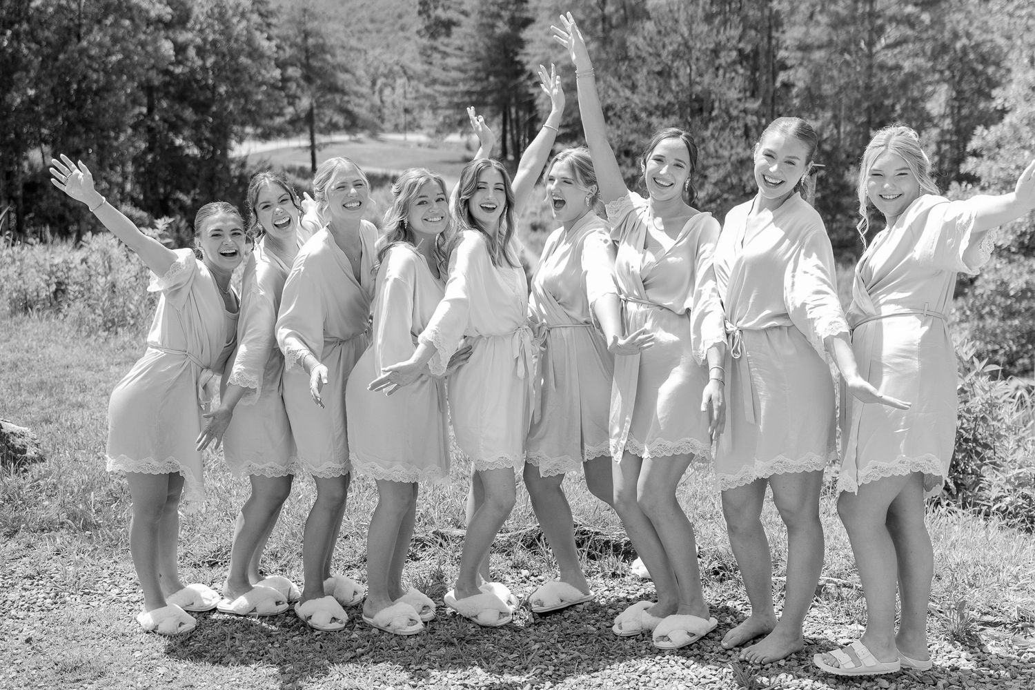 A series of black and white photos showing a group of people posing outdoors in matching white outfits.