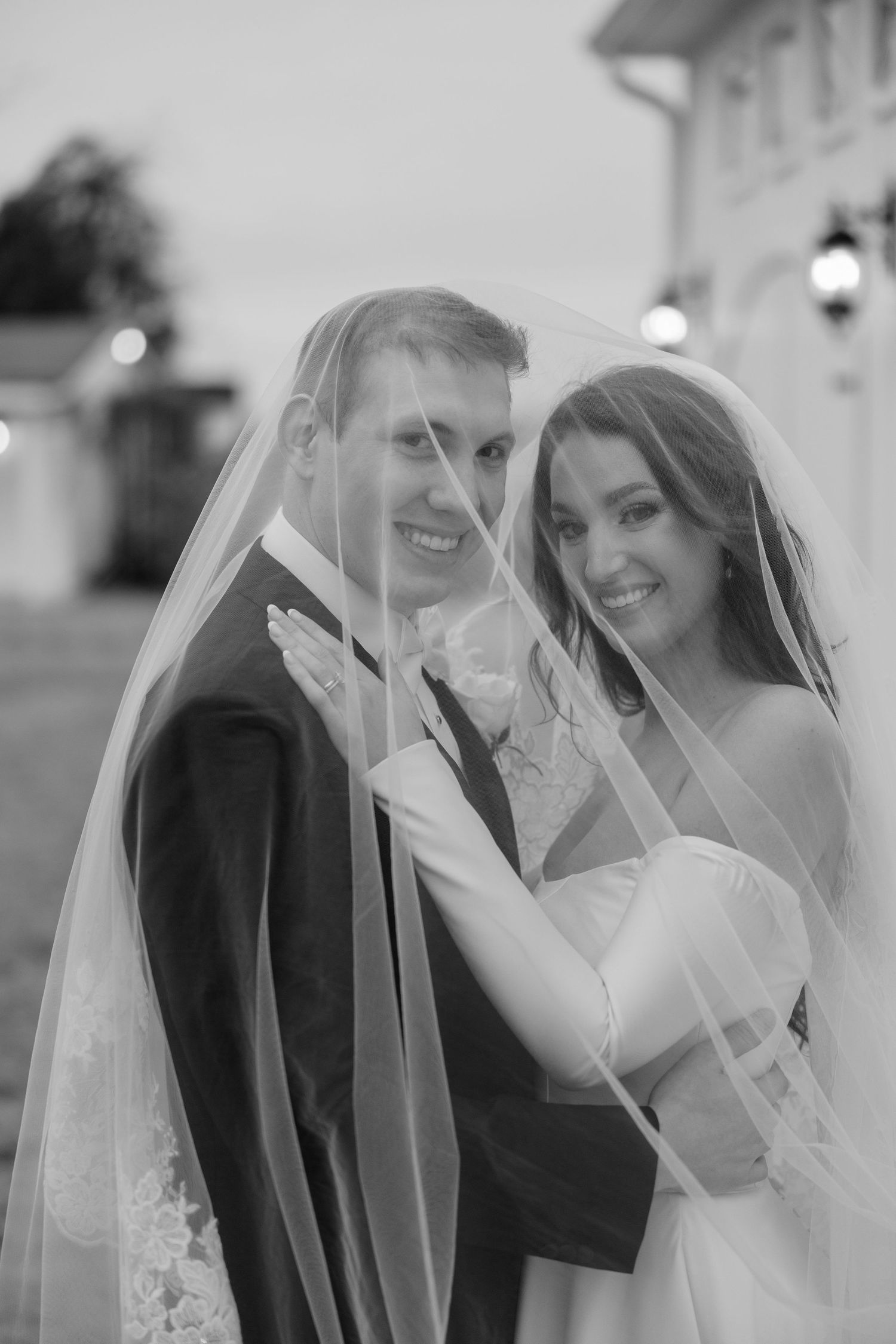 Close up series of romantic moments under a wedding veil against a light background.