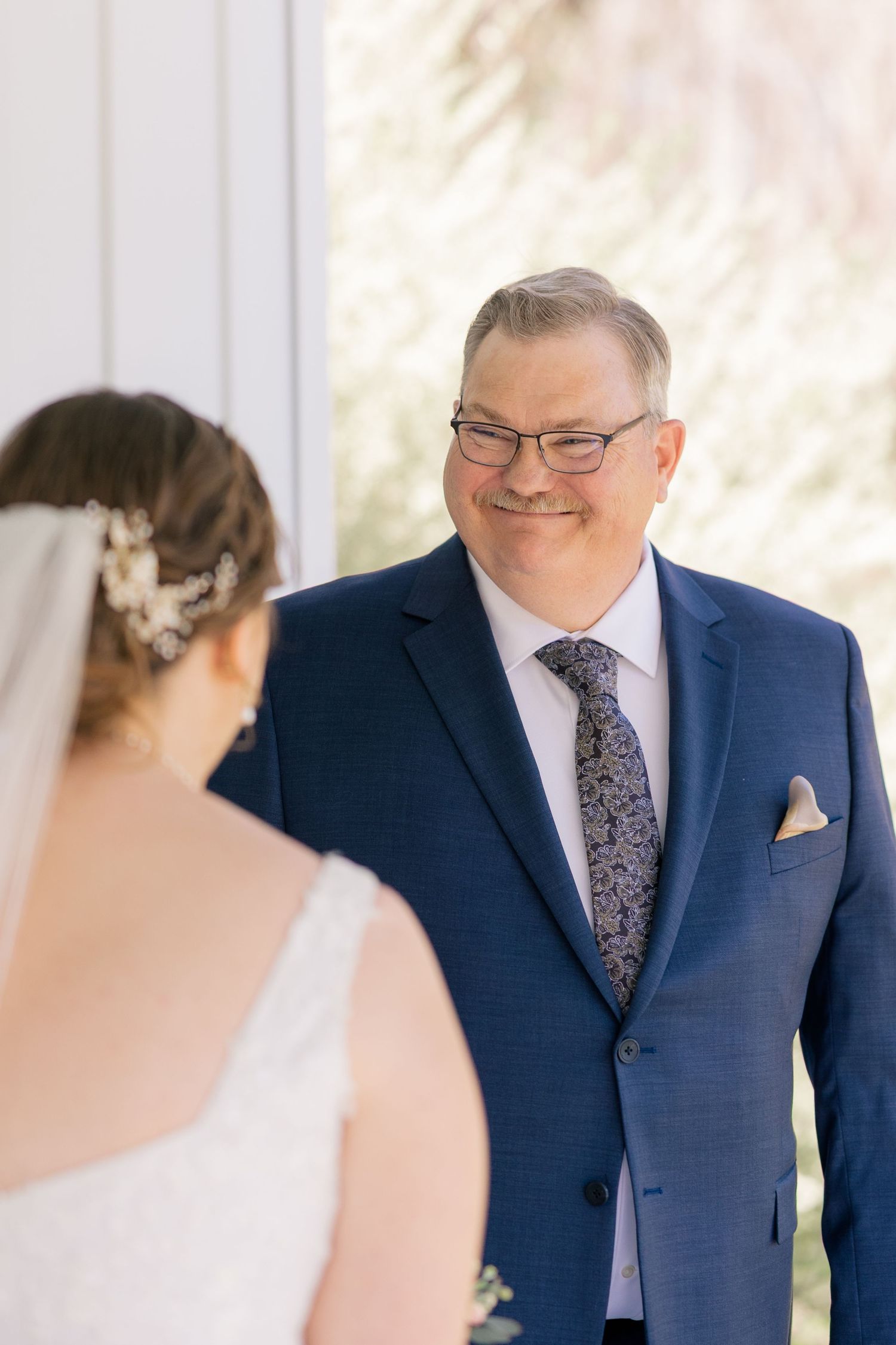 A wedding day first look moment captured between two people.
