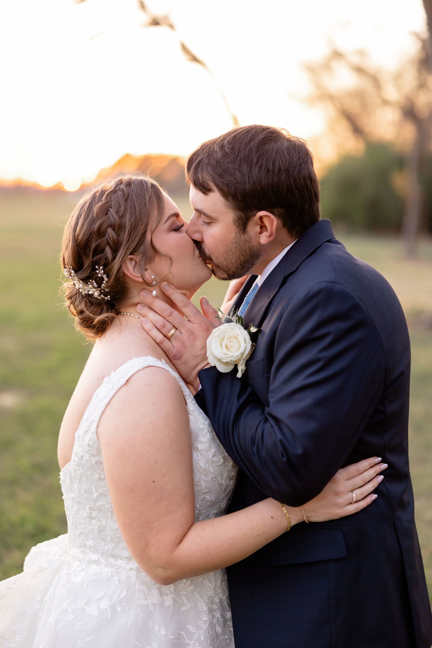 A romantic sunset moment captured during a wedding celebration outdoors.