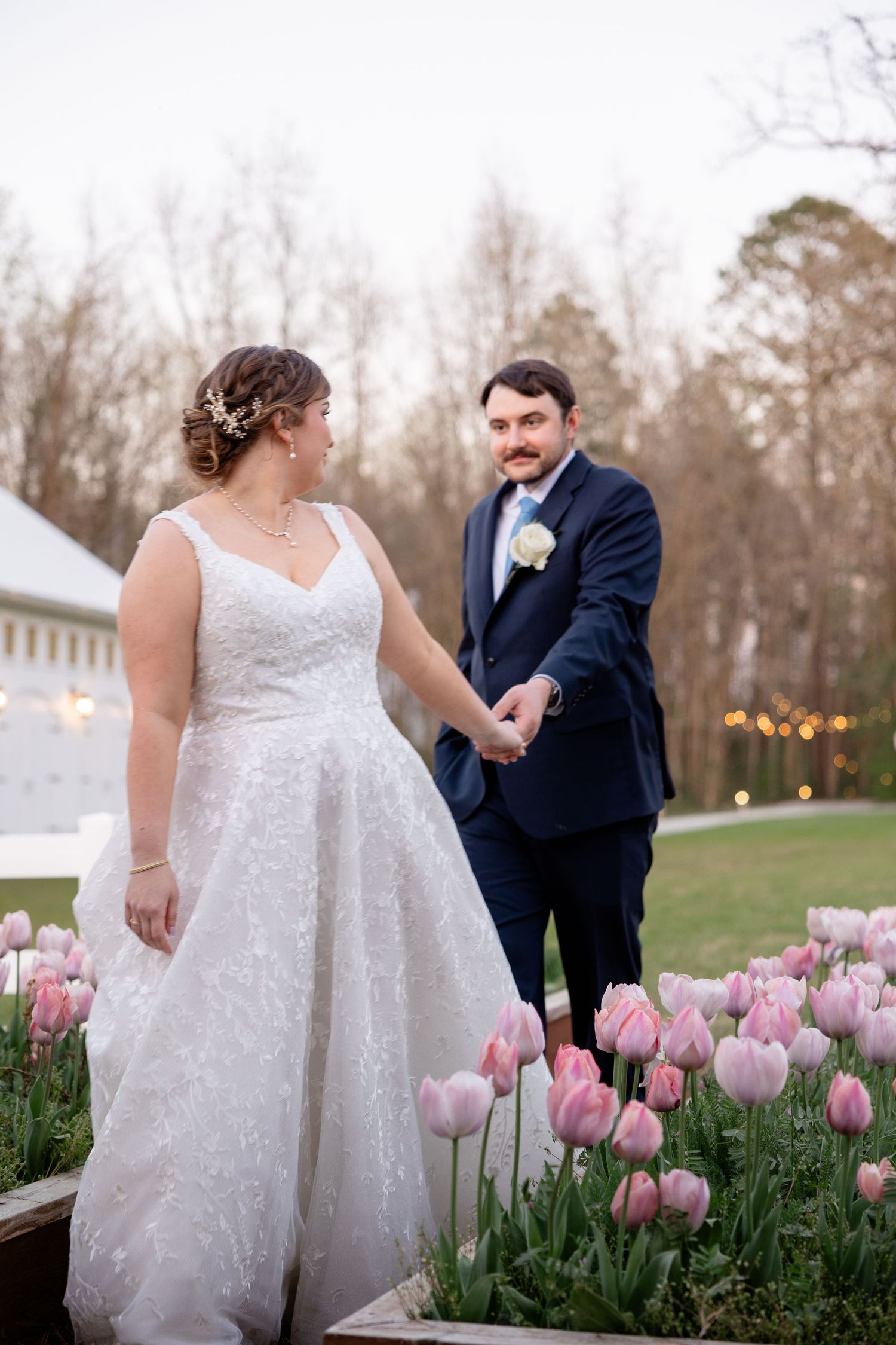 Beautiful spring garden wedding scene with blooming pink tulips and evening lighting.