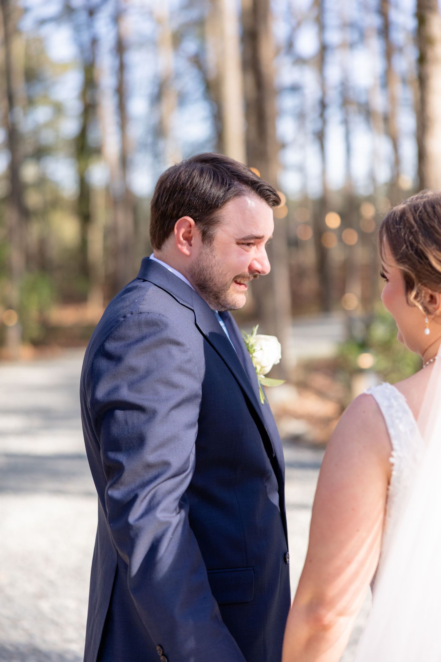 Wedding couple sharing an intimate first look moment outdoors.