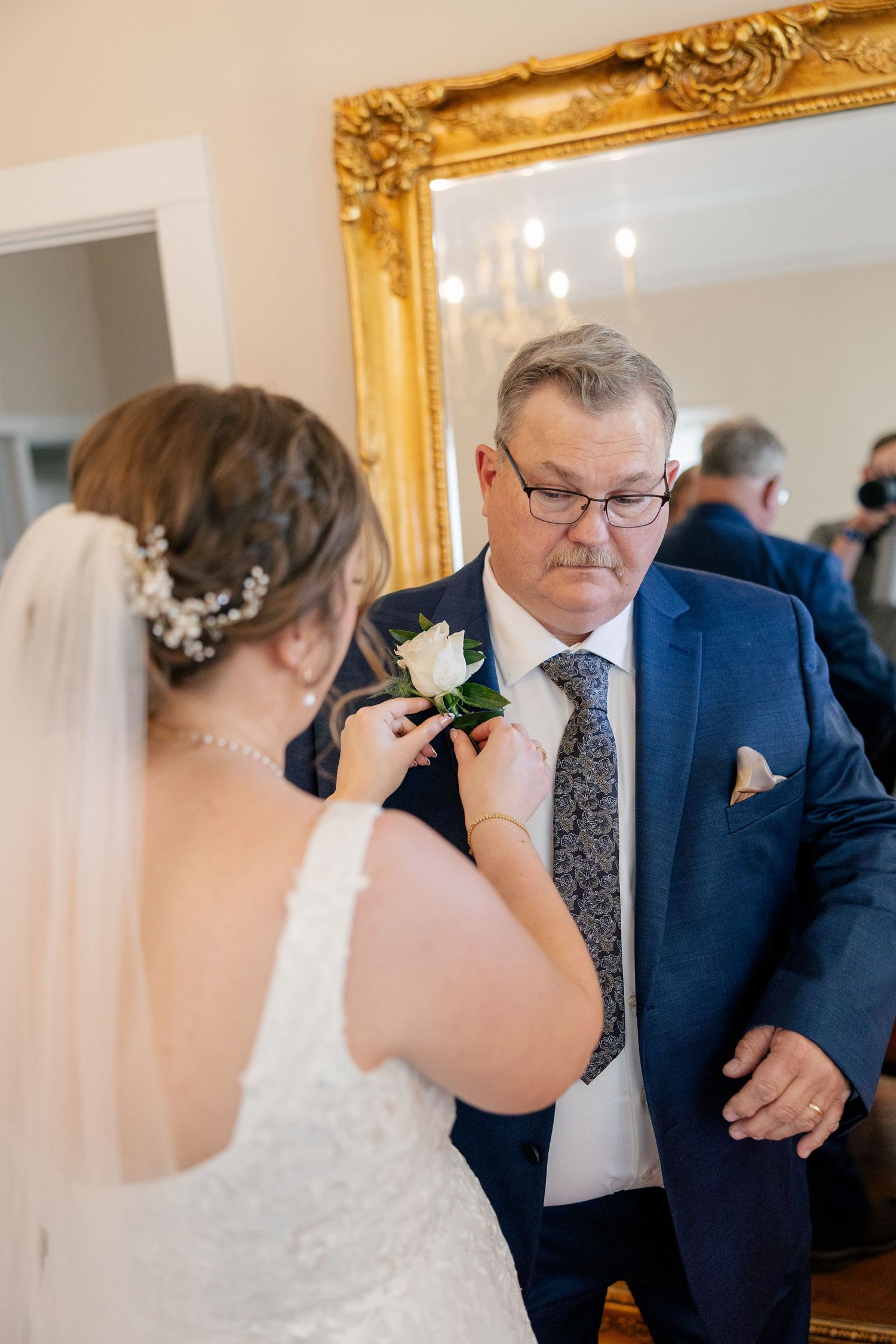 Intimate first look moment between the bride and family member in formal attire.