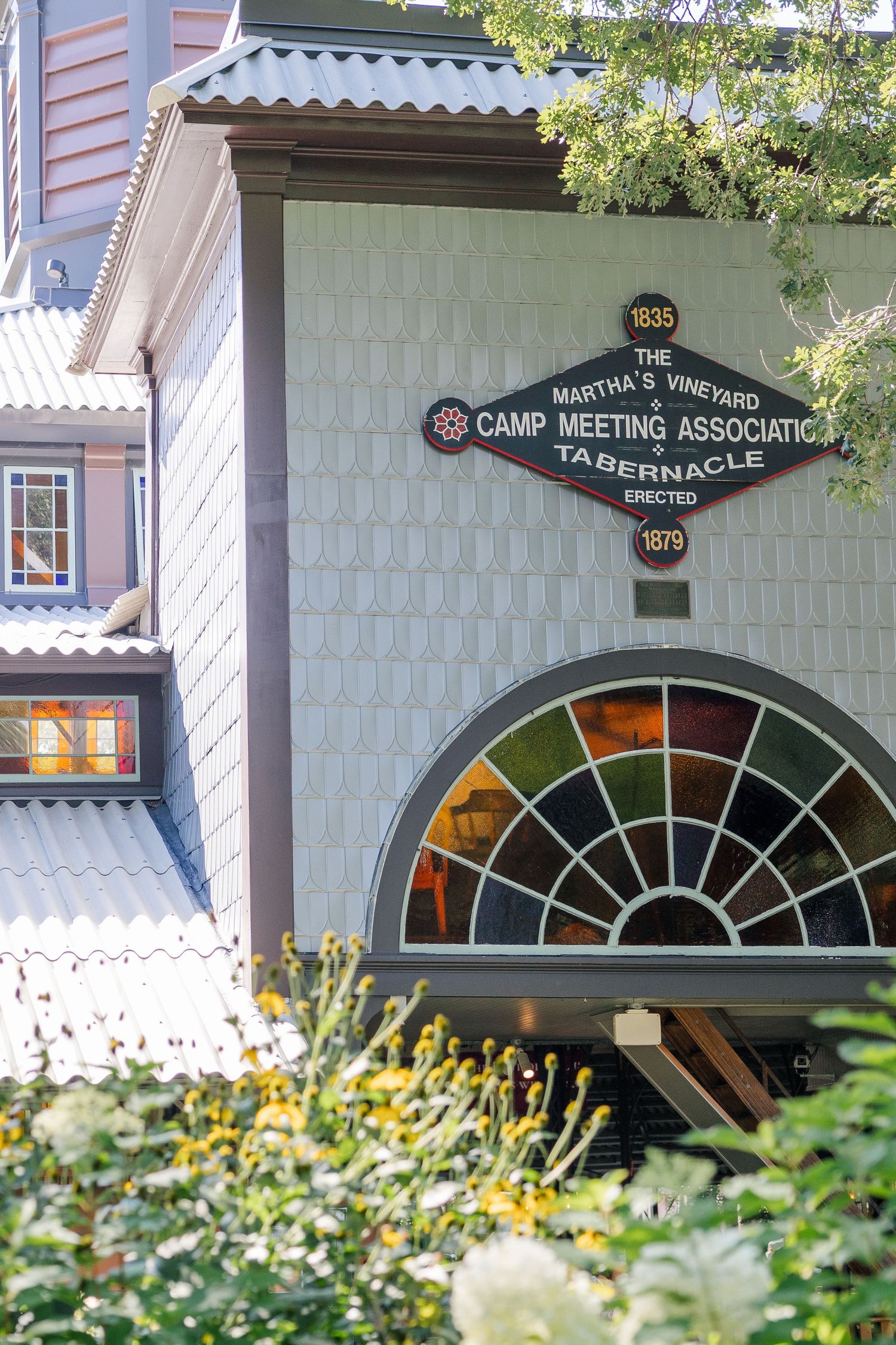 The historic Martha's Vineyard Camp Meeting Association Tabernacle, established 1835, features a stunning stained glass window.