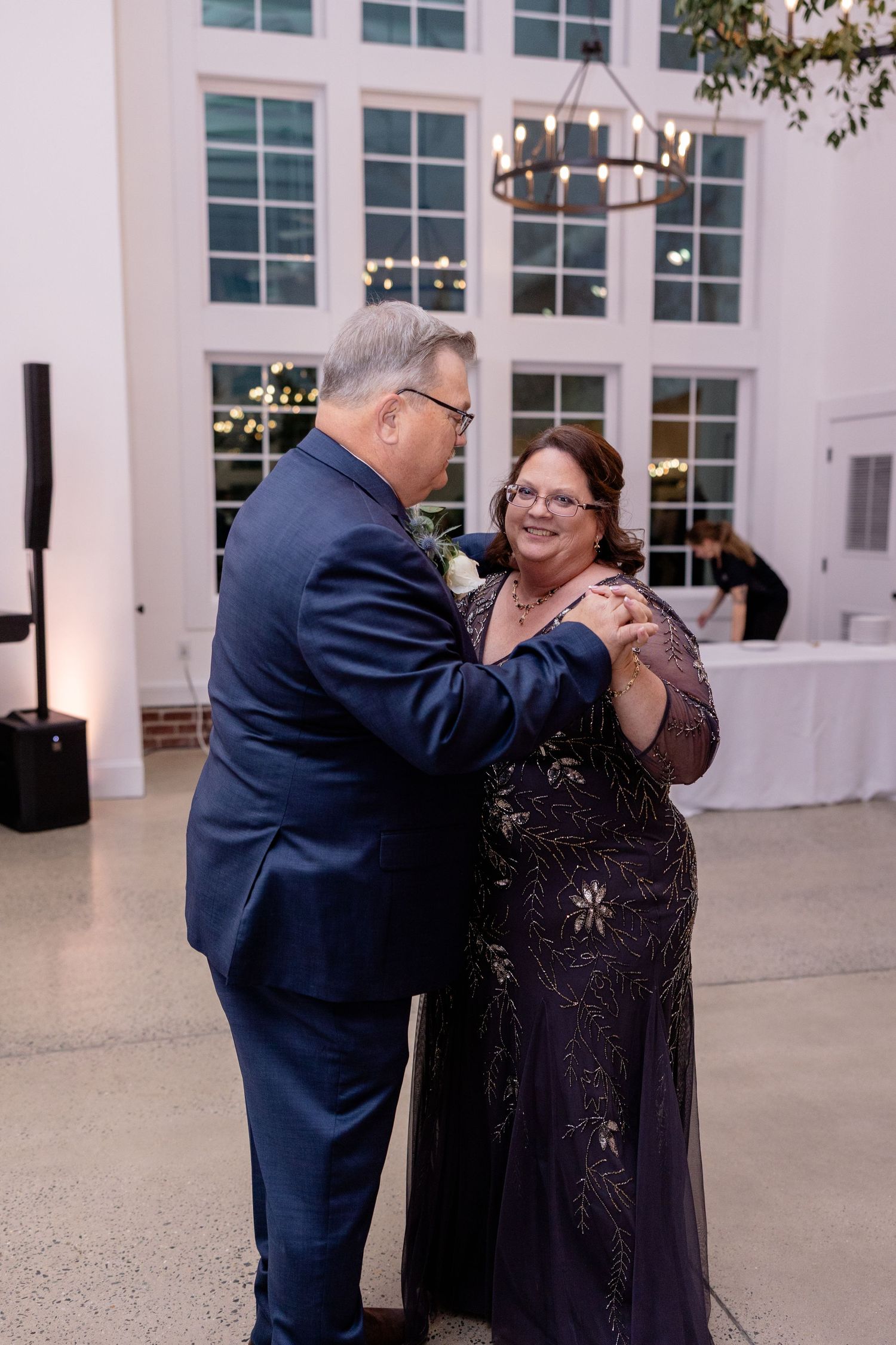 Couple dancing together at an indoor wedding reception.
