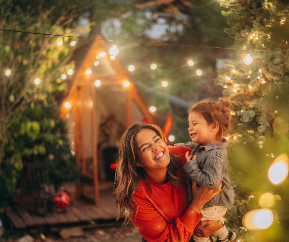 A warm outdoor scene with string lights glowing in a garden at sunset creating a magical atmosphere.