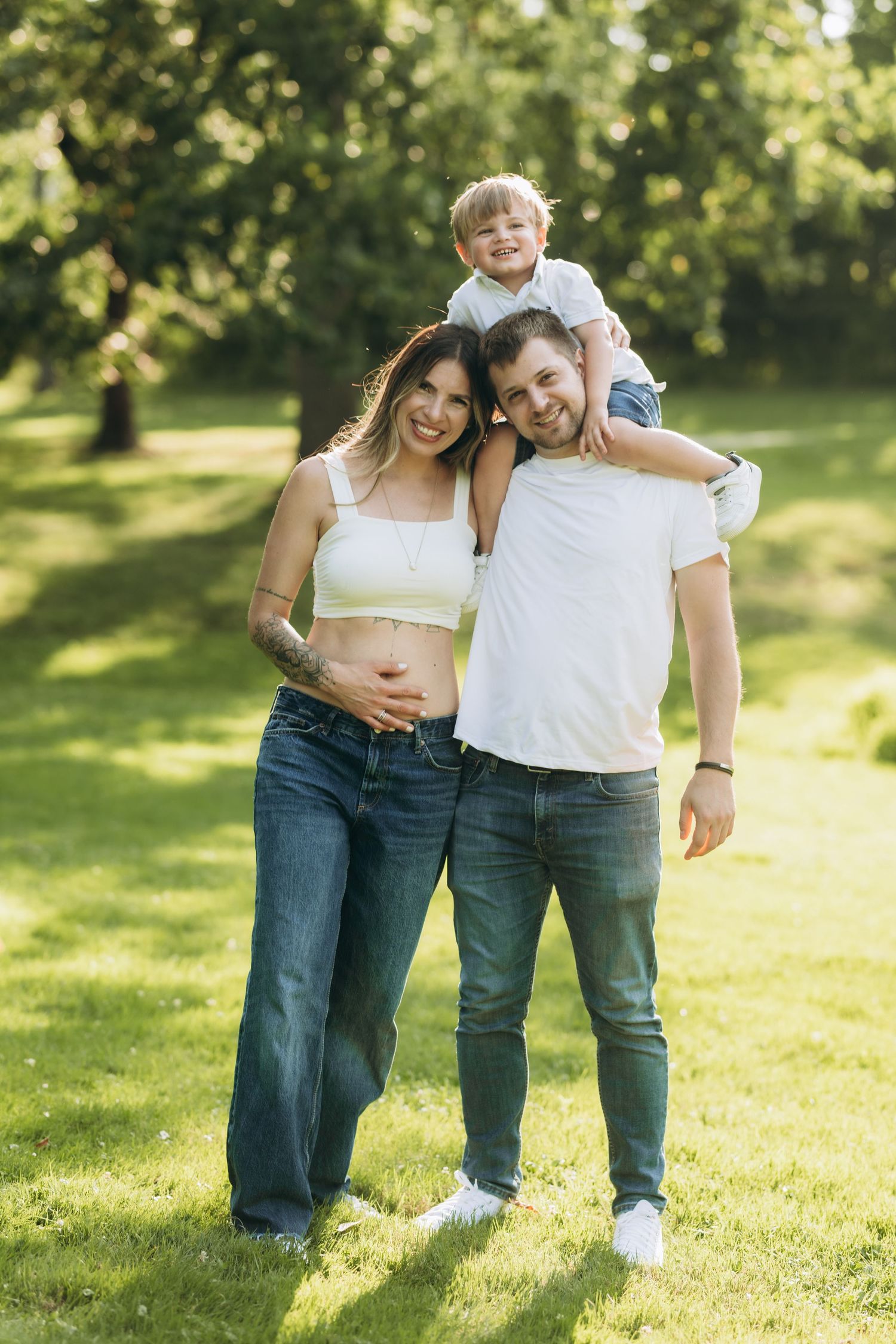 A small group enjoying a sunny day together on a grassy lawn in summer casual clothing.