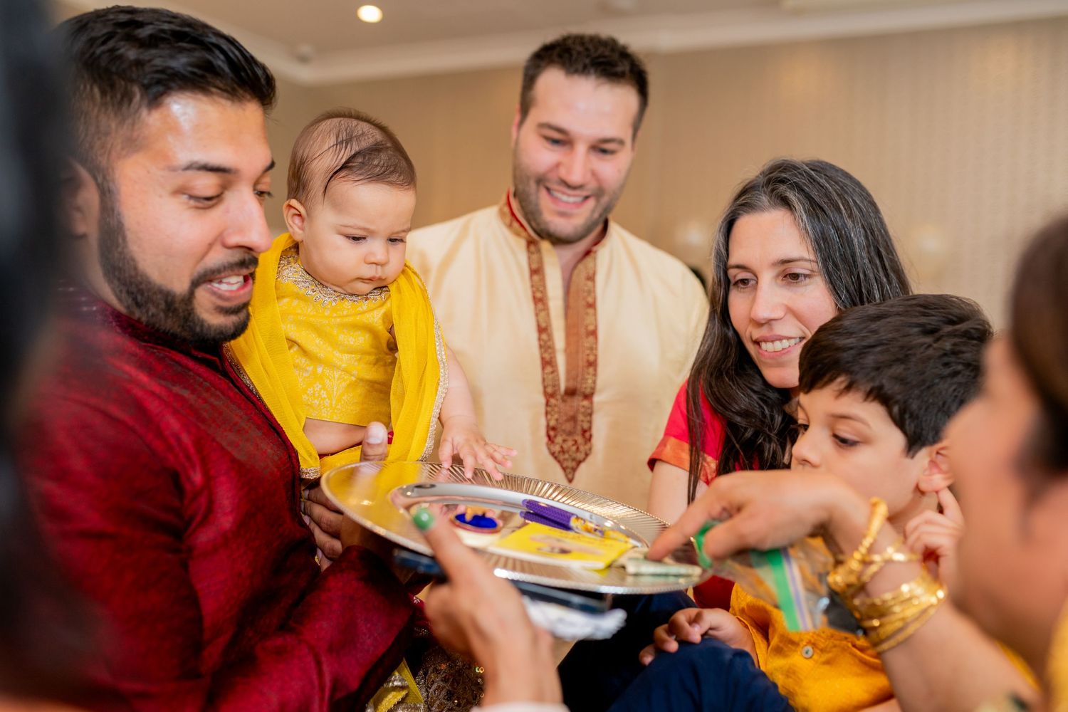 Family sharing traditional Indian meal together at celebration gathering.
