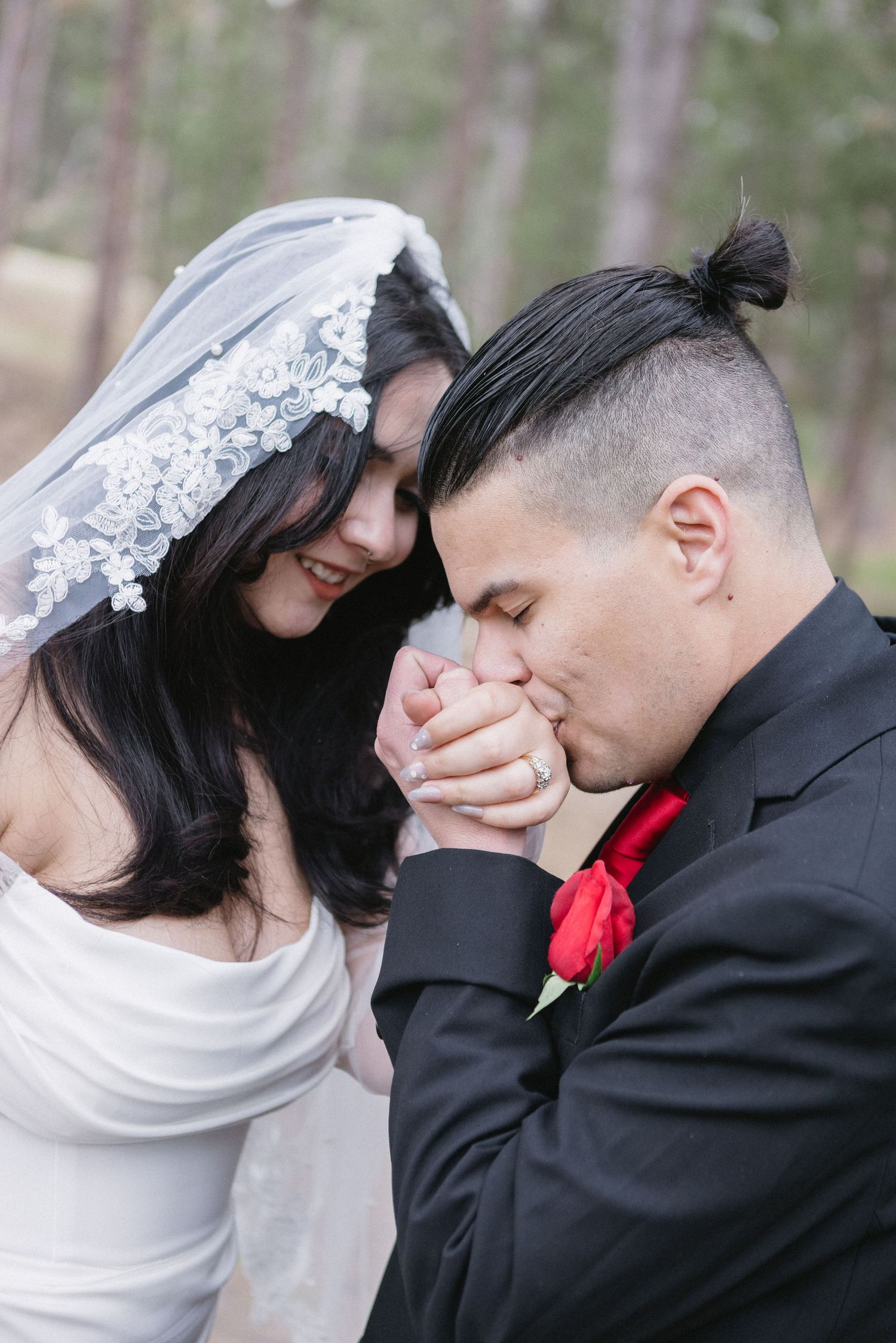 A romantic sequence of wedding photographs shows a couple sharing tender kisses in a woodland setting.