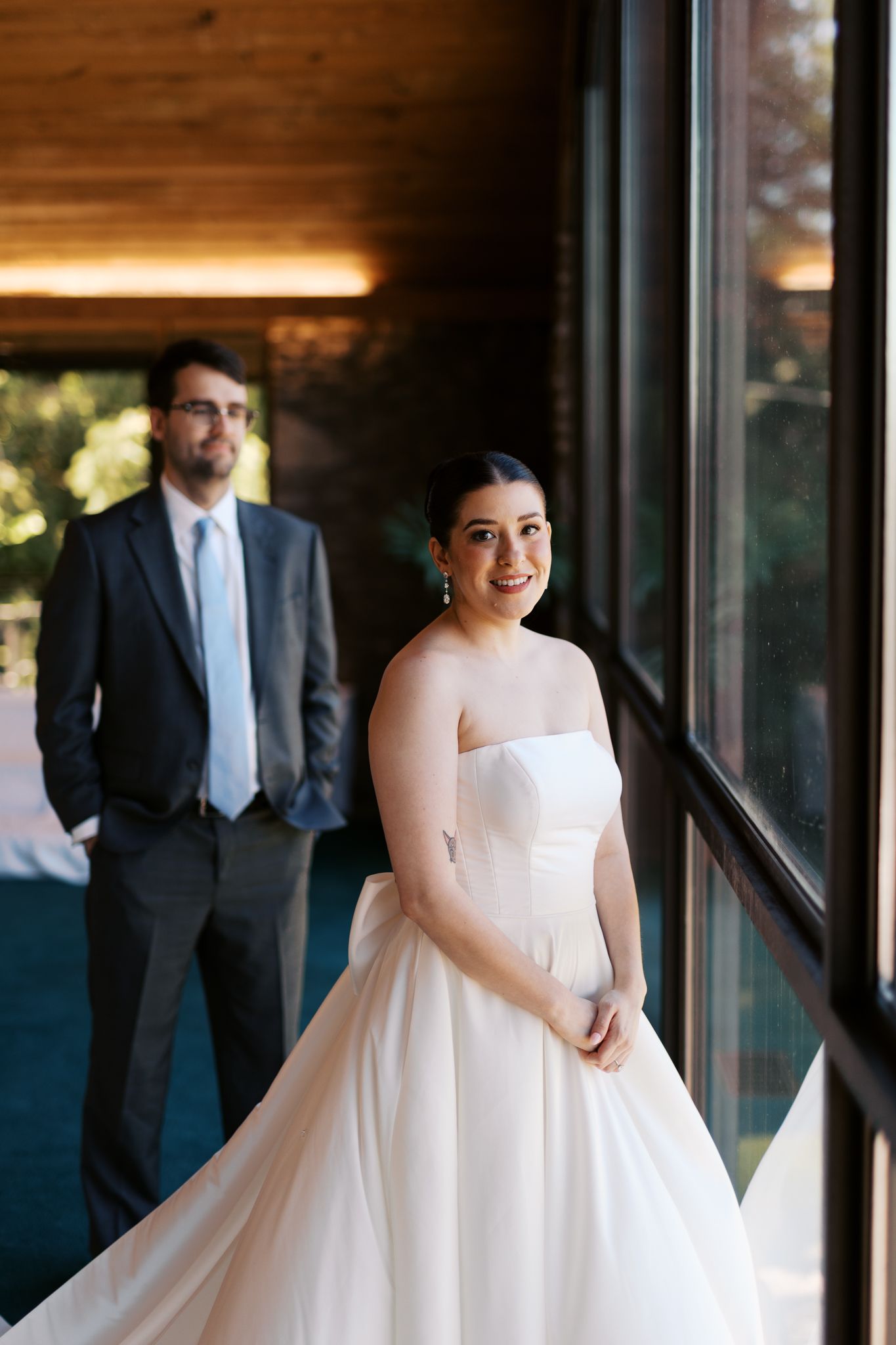 Elegant bridal portrait session in a modern venue with floor-to-ceiling windows.