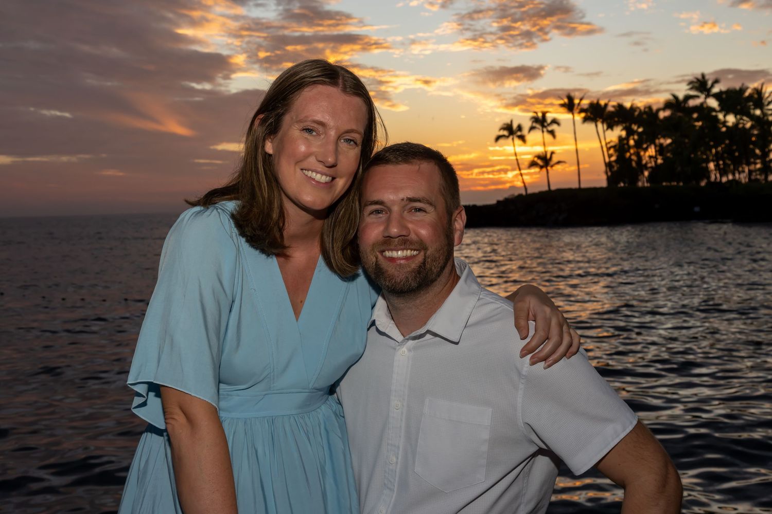 Our Kailua-Kona portrait photographer captures a couple against a stunning sunset sky along the Kona Coast. *