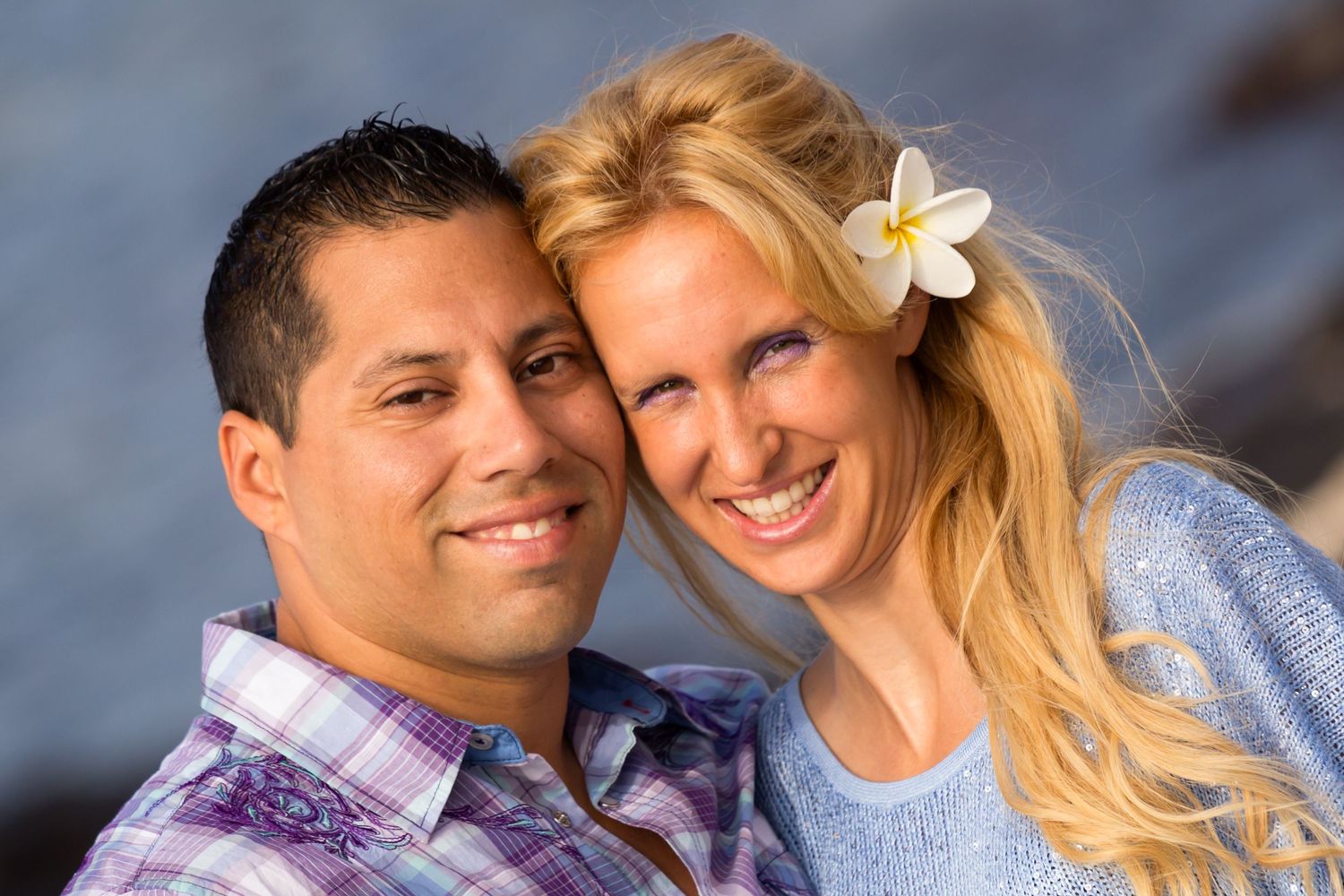 A close-up of a couple sharing tender moments during their sunset engagement photo session in Kailua Kona, Hawaii.