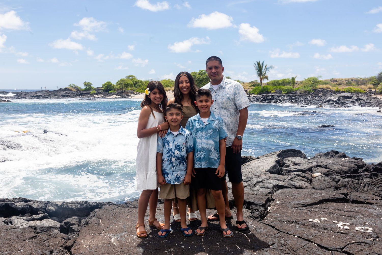 A collage shows scenic Hawaiian beach views with crashing waves and black lava rocks along the coastline.
