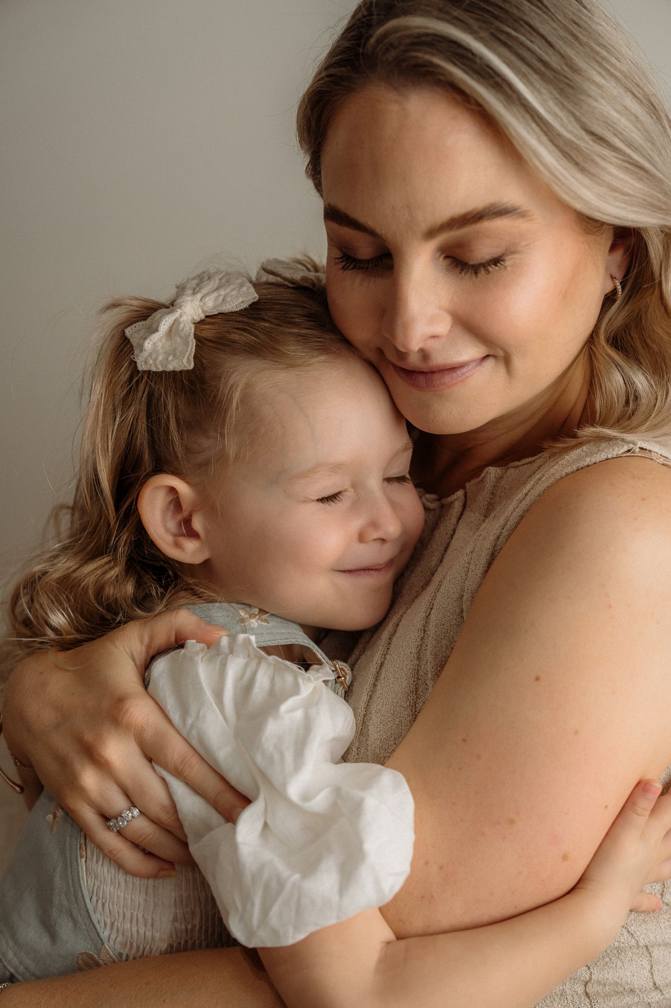 A tender moment captured between parent and child sharing a warm embrace in soft natural light.