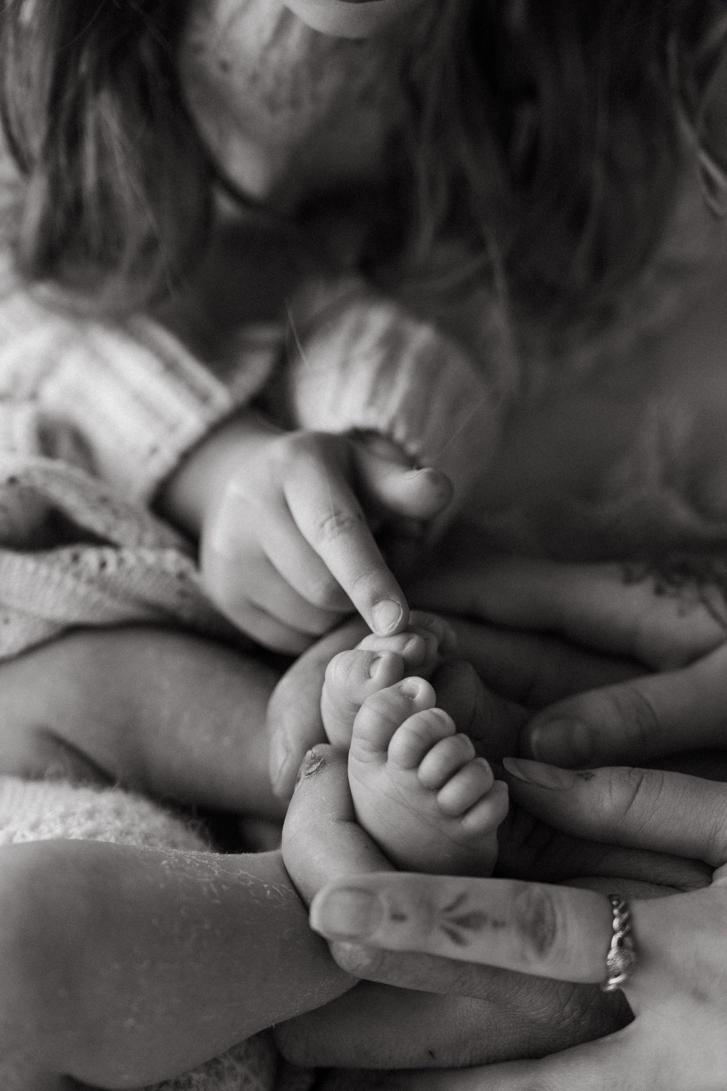 A black and white photograph montage showing hands holding and clasping together in various intimate poses.
