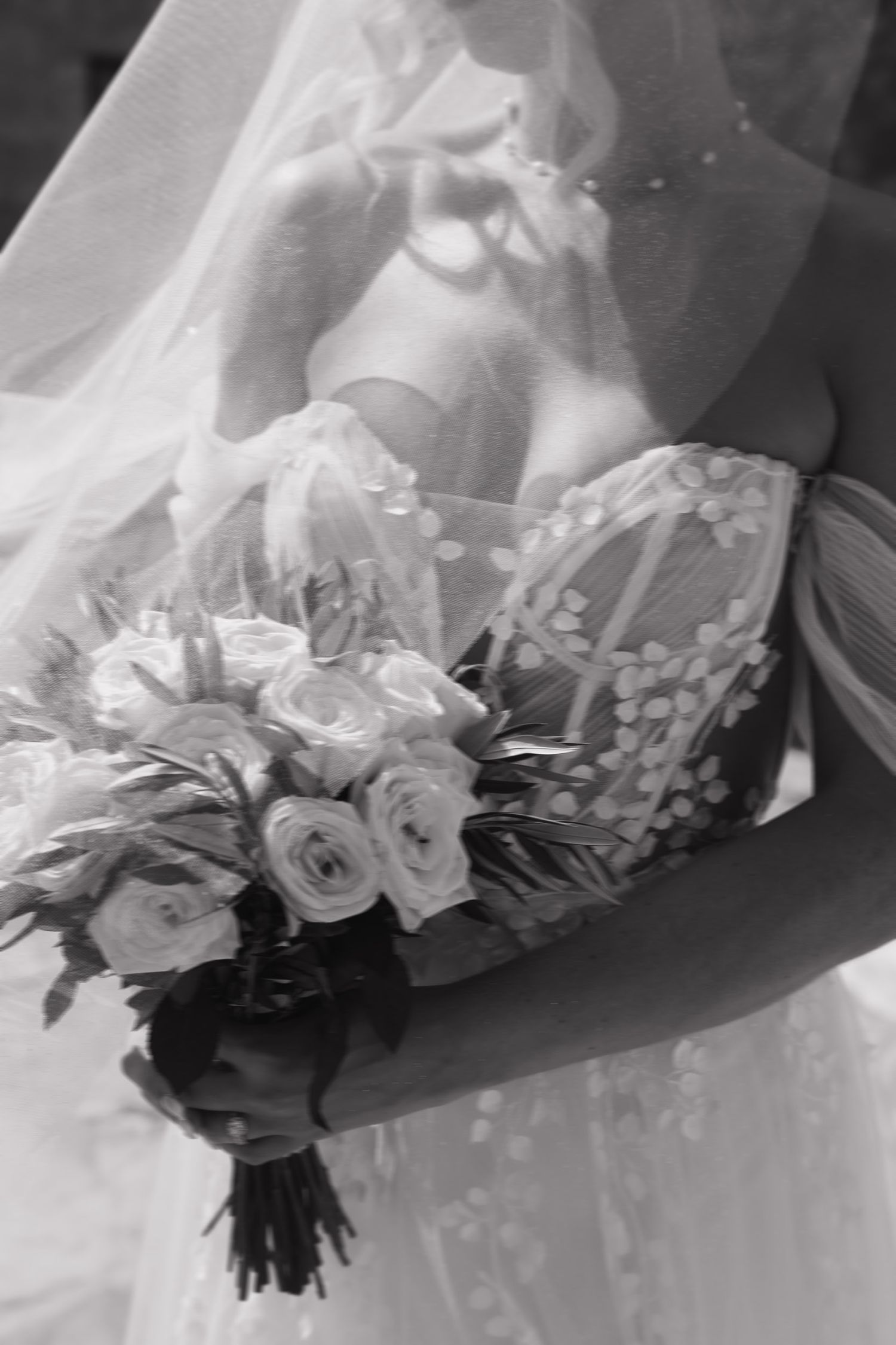 A black and white wedding photo series showing a bridal bouquet with roses and hydrangeas from different angles.