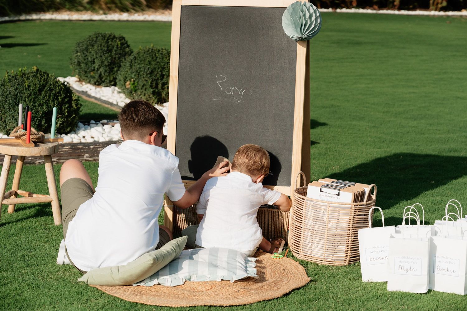 A series of candid outdoor wedding photos showing guests sitting on blankets and enjoying a picnic-style reception.