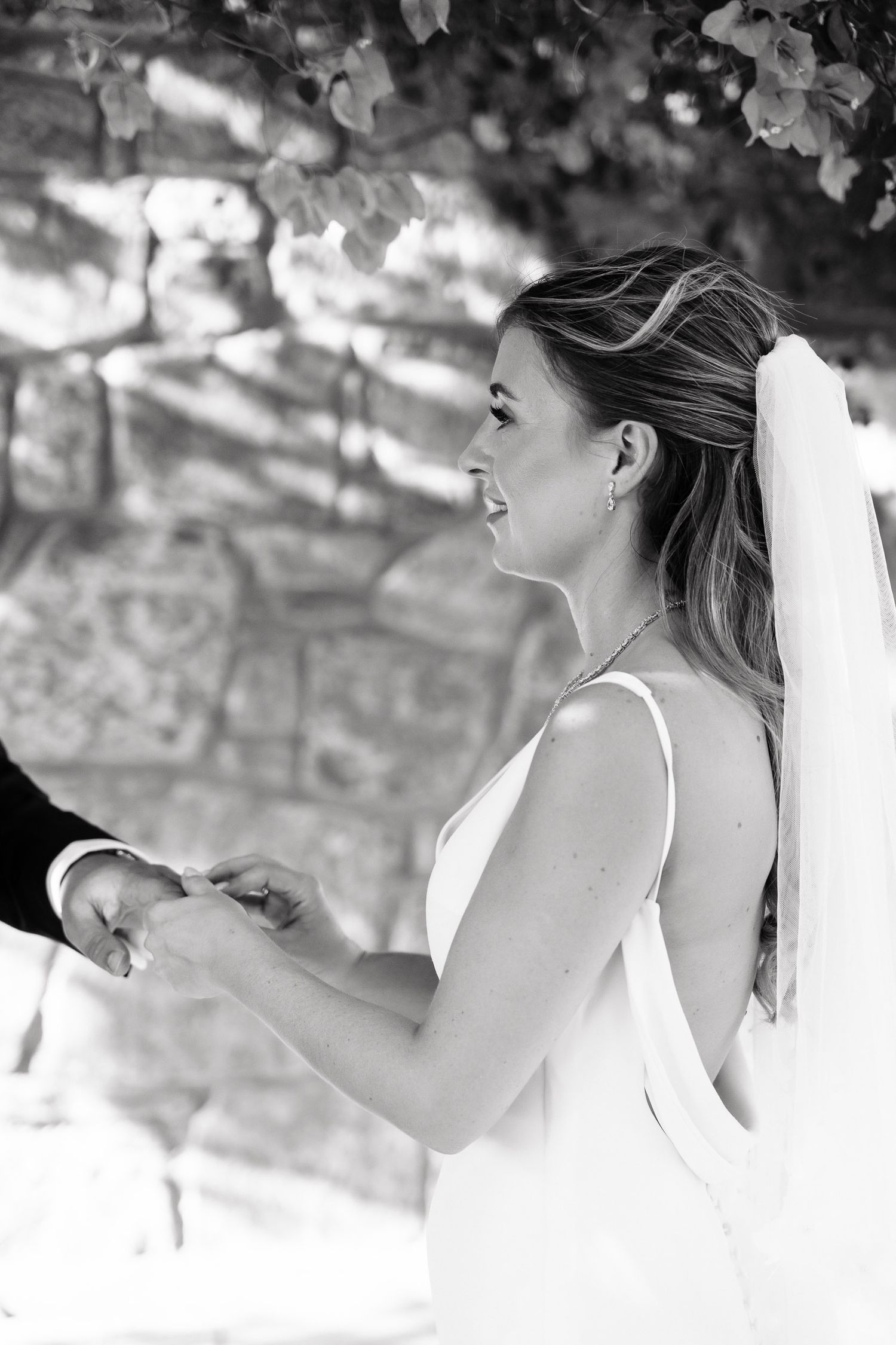 A black and white photo sequence showing a bride in a white dress laughing and expressing joy during a candid moment.