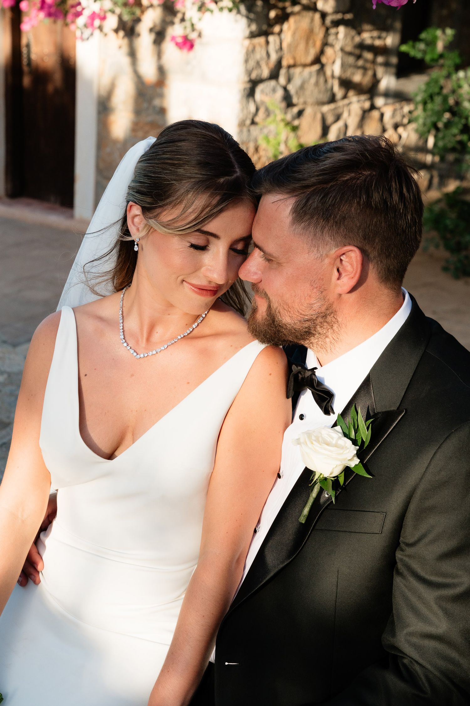 A romantic wedding couple shares intimate moments in a series of black and white photos showing tender kisses and embraces.