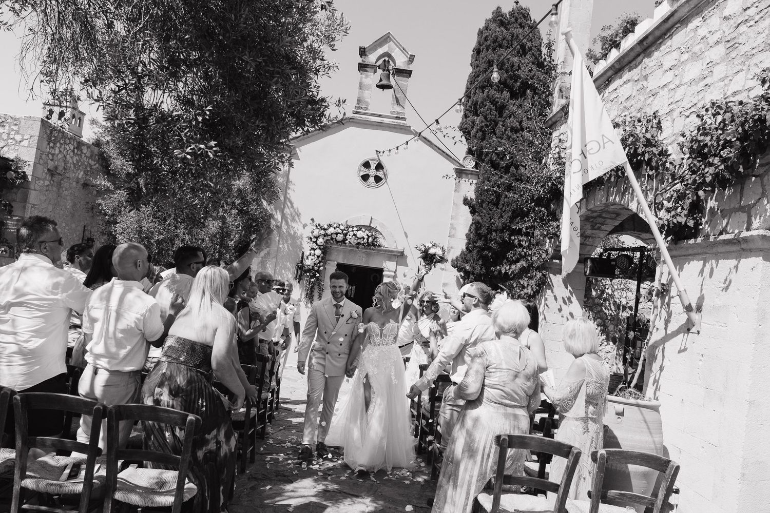 Black and white photo series showing outdoor wedding ceremony with guests seated in chairs and floral decorations.