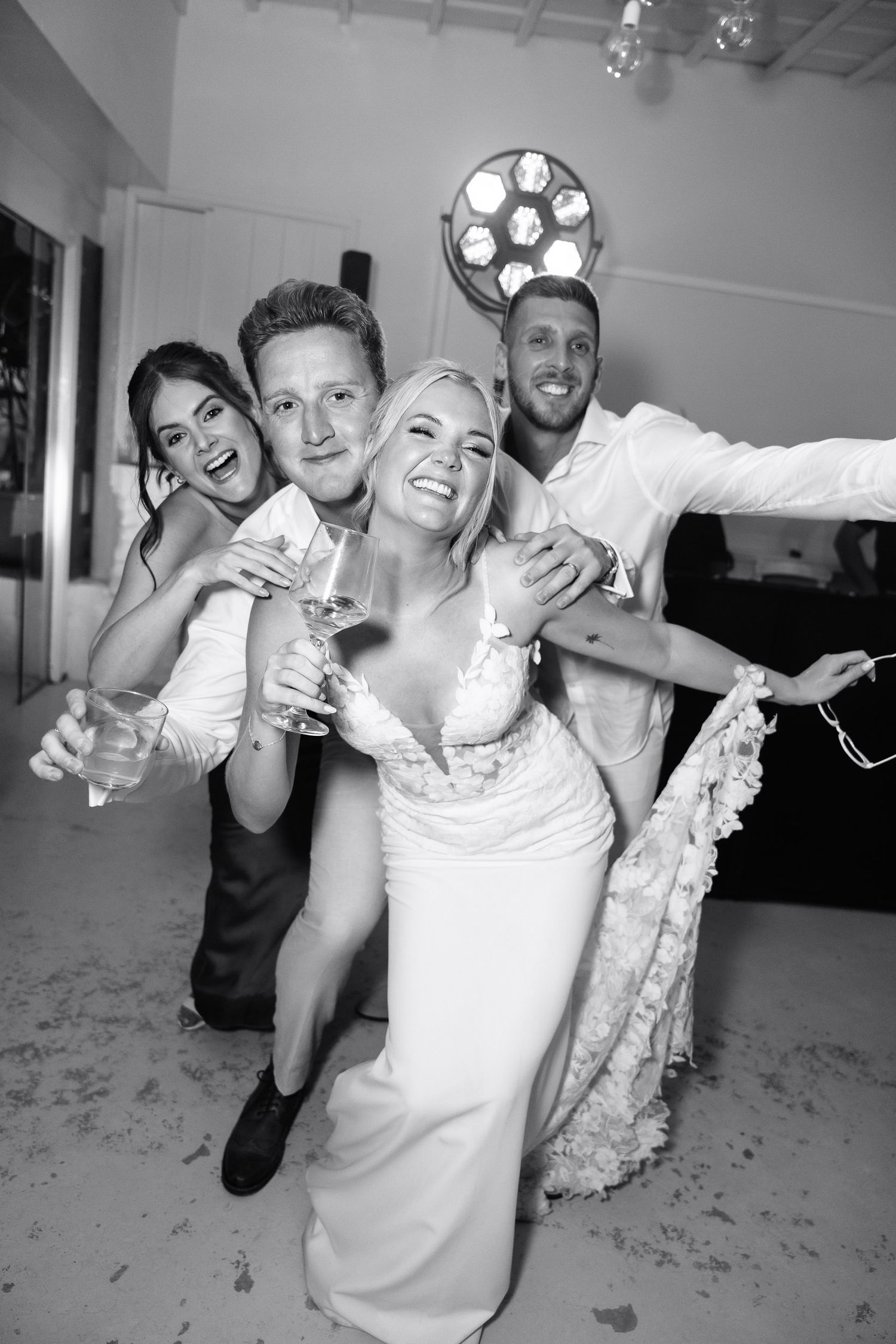 Black and white wedding reception photos show joyful dancing and celebration on the dance floor.