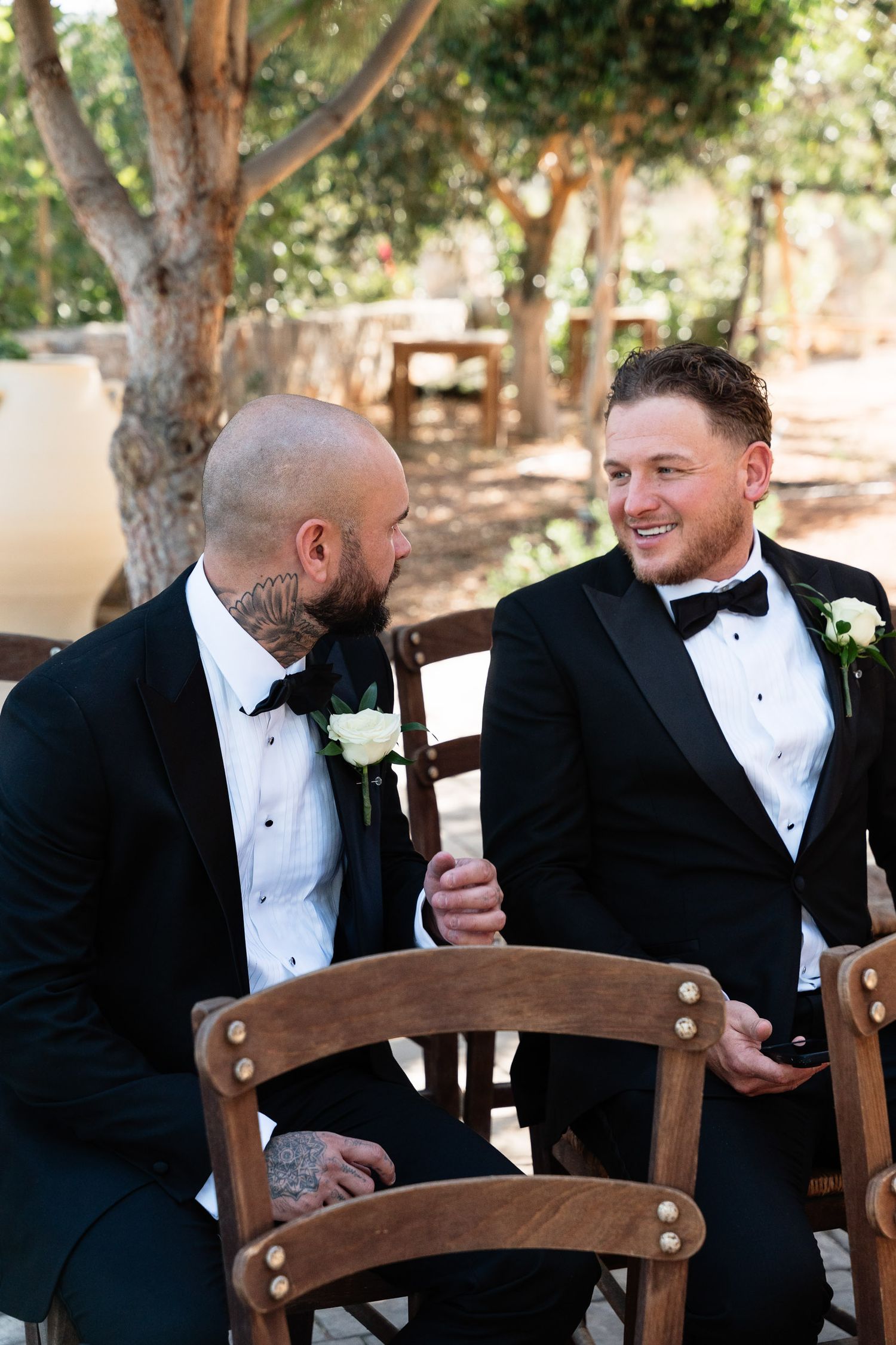 A sequence of five photos shows groomsmen in black tuxedos sharing laughter and conversation during a wedding celebration.