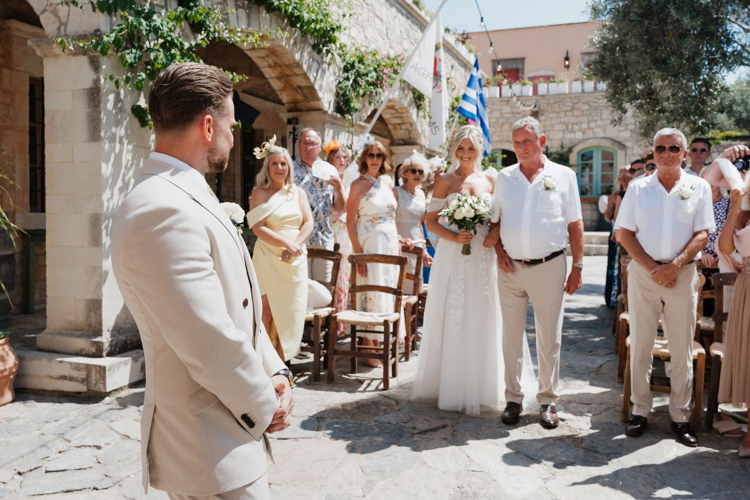 A collage of wedding celebration moments showing guests in white and beige attire gathered at an outdoor venue.