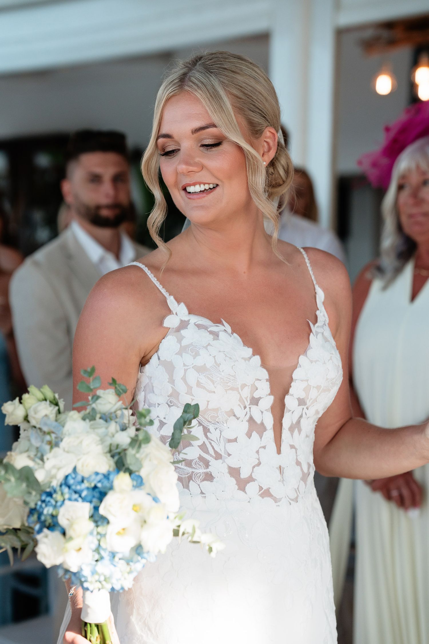 A series of wedding photos showing a bride in a white lace dress holding a bouquet of white and blue flowers.