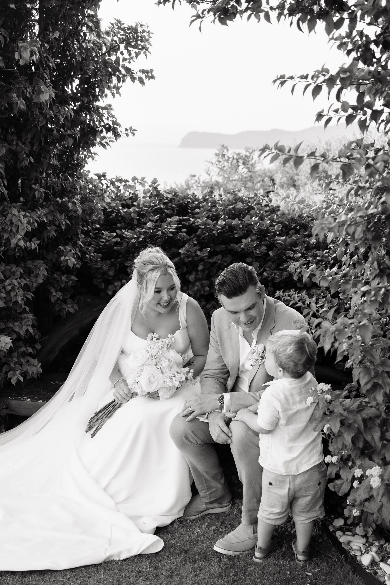 A sequence of black and white photos showing tender moments between a bride in a wedding dress and a small child.