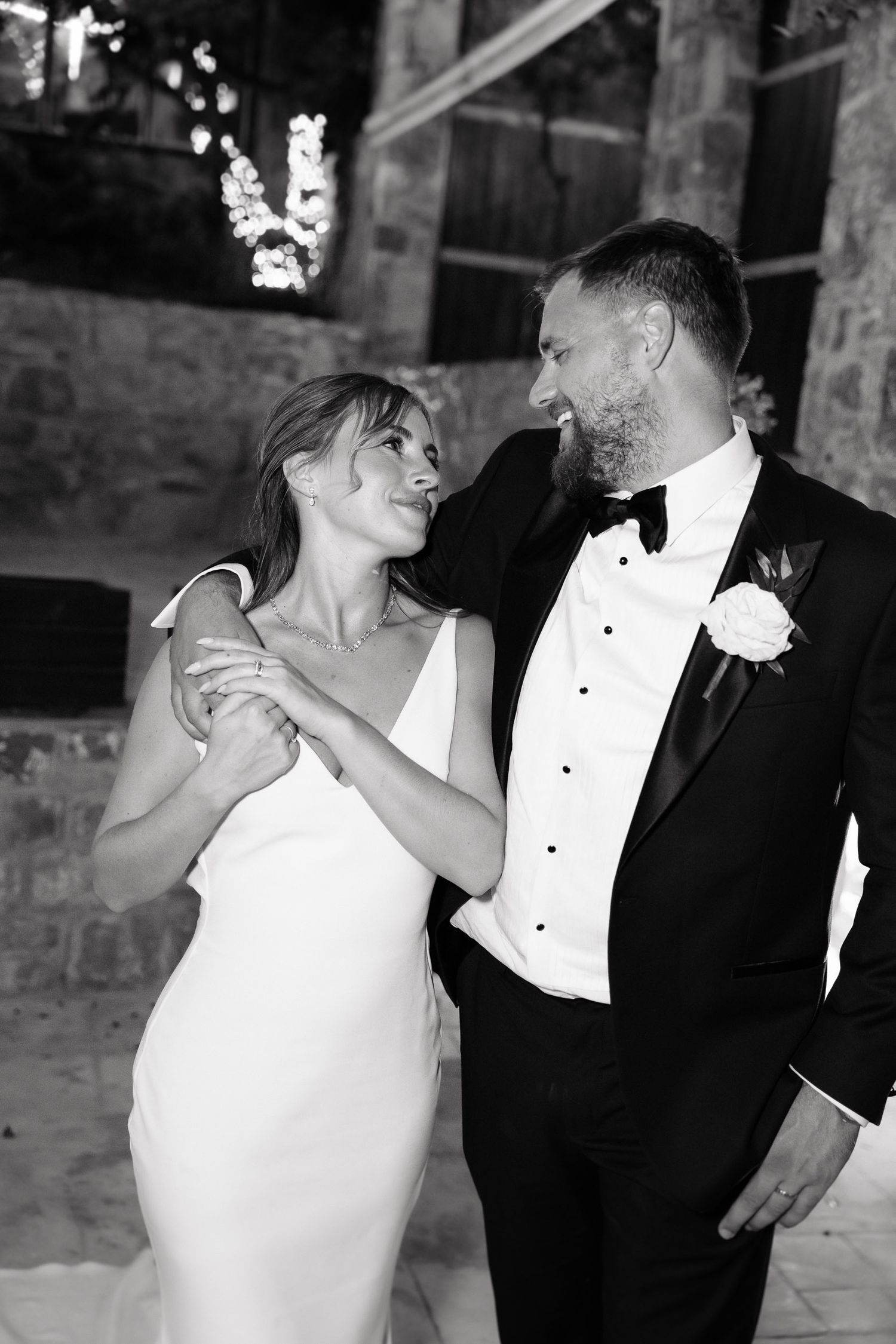 A romantic sequence of wedding photos showing a couple in formal attire dancing and embracing in a rustic stone venue.