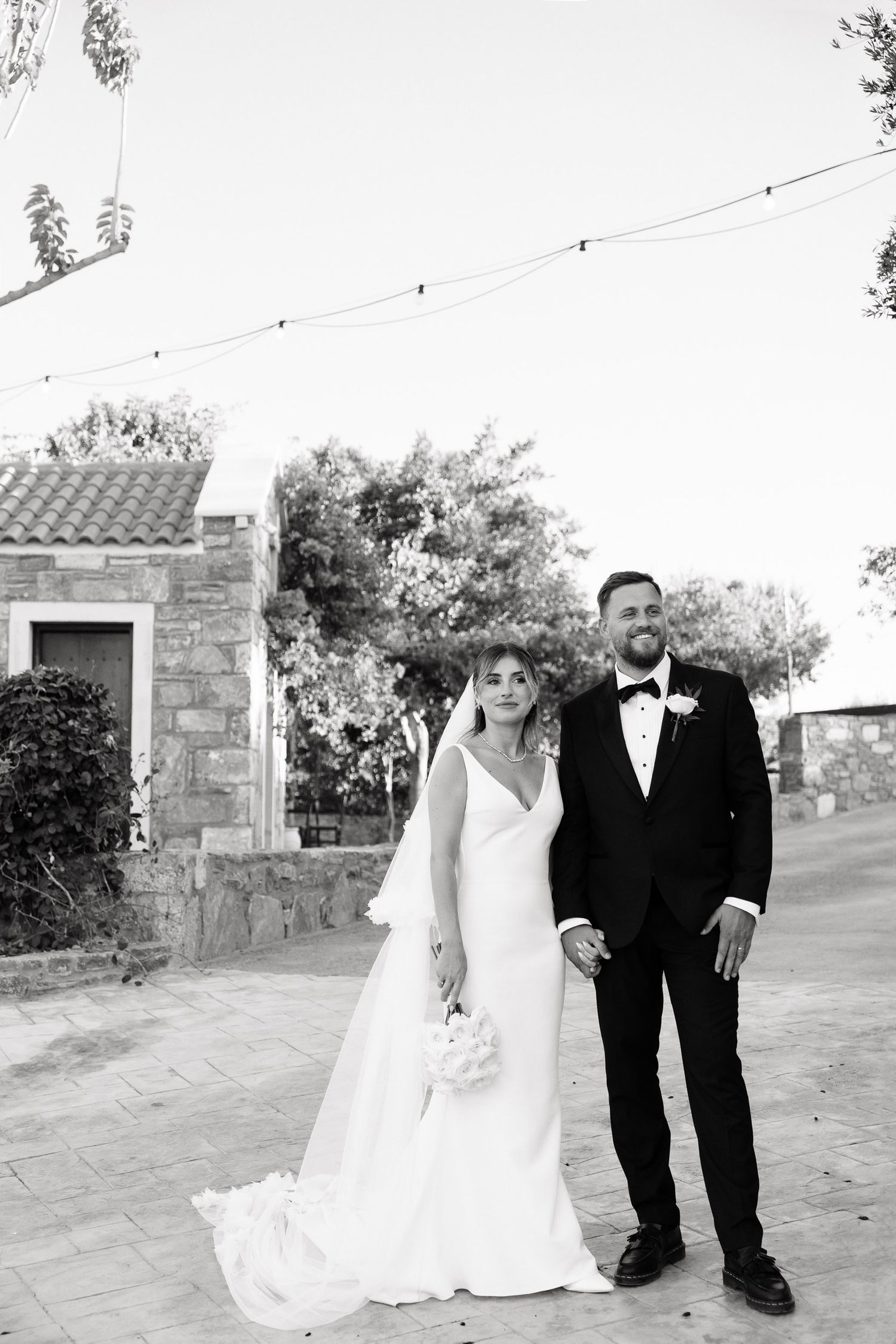 A series of wedding photos showing a couple walking together outdoors in formal attire at a rustic venue.