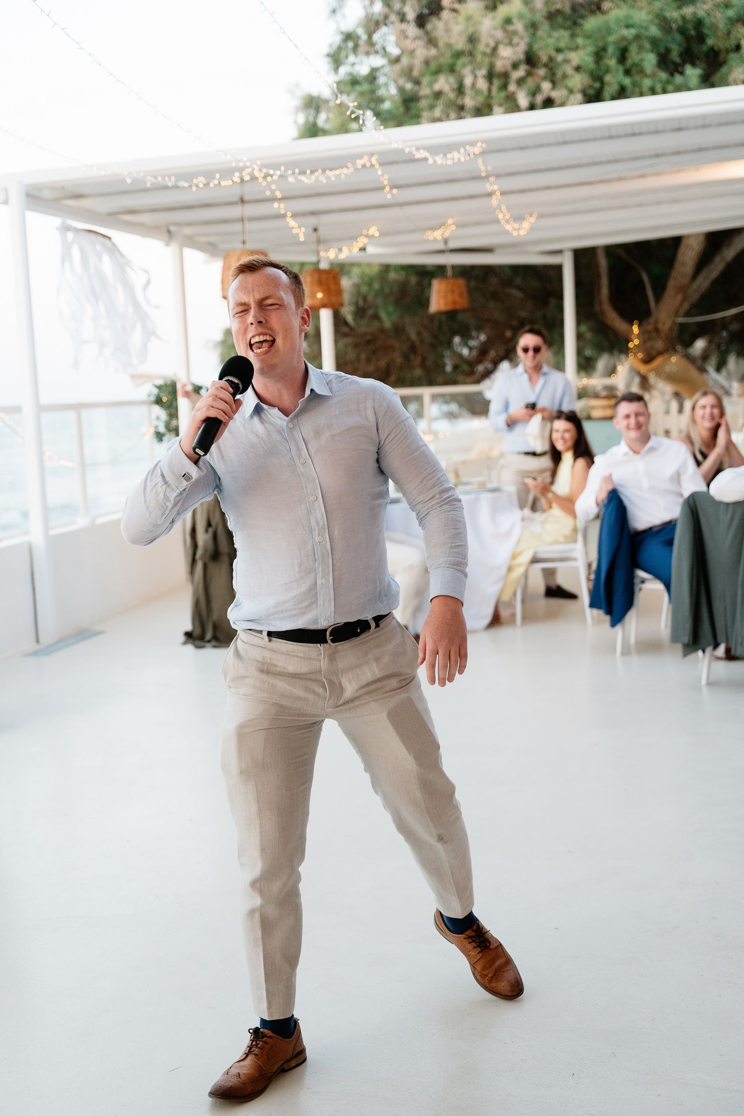 A sequence of dance moves shows someone performing energetic steps on a white dance floor at a reception venue.