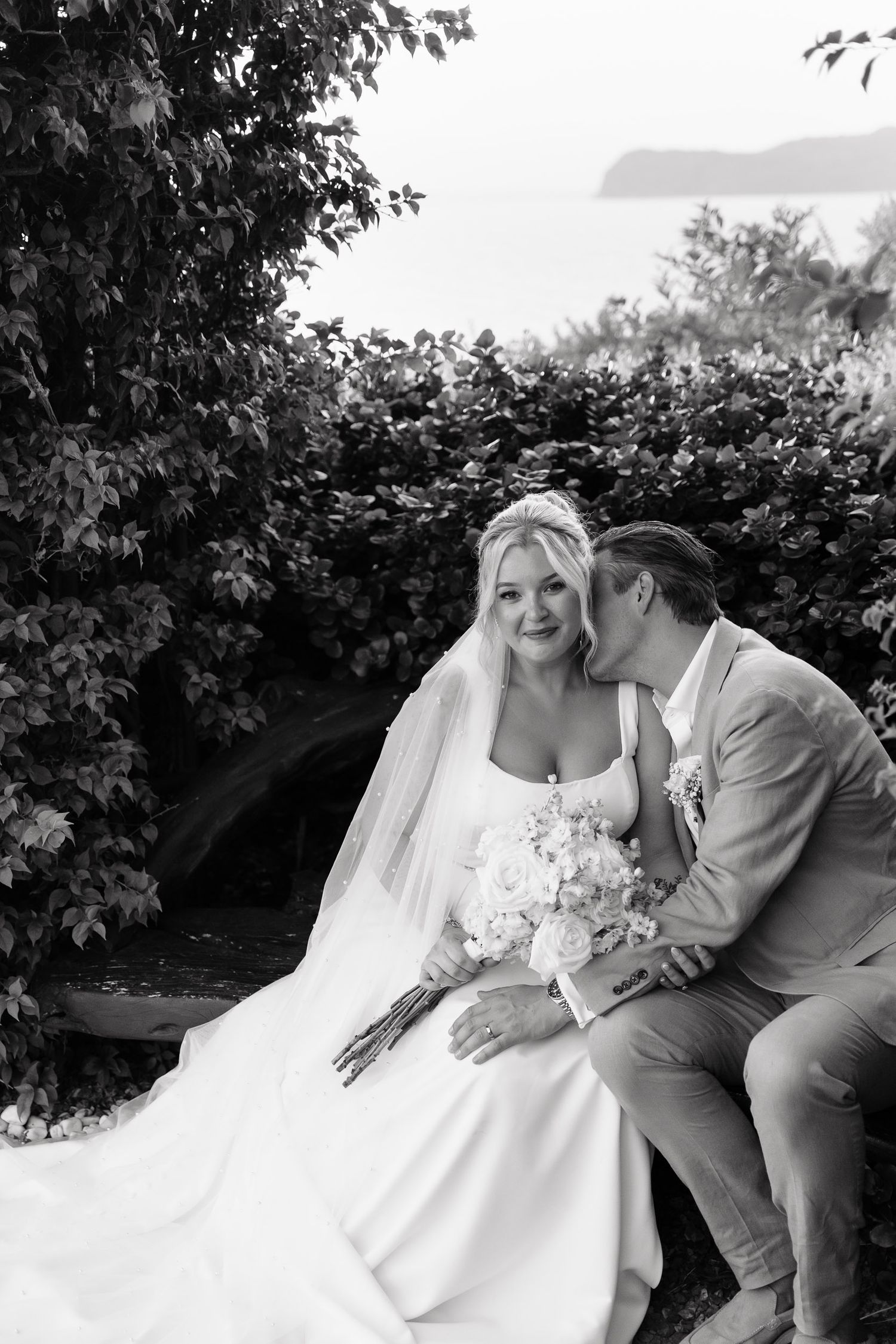 A romantic black and white photo sequence shows a couple on a bench sharing tender moments in their wedding attire.