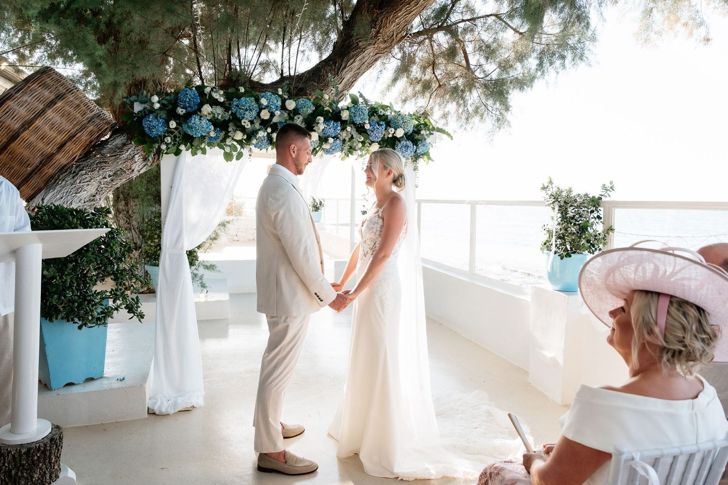 A series of wedding photos showing intimate moments between a couple in a bright, airy Mediterranean setting.