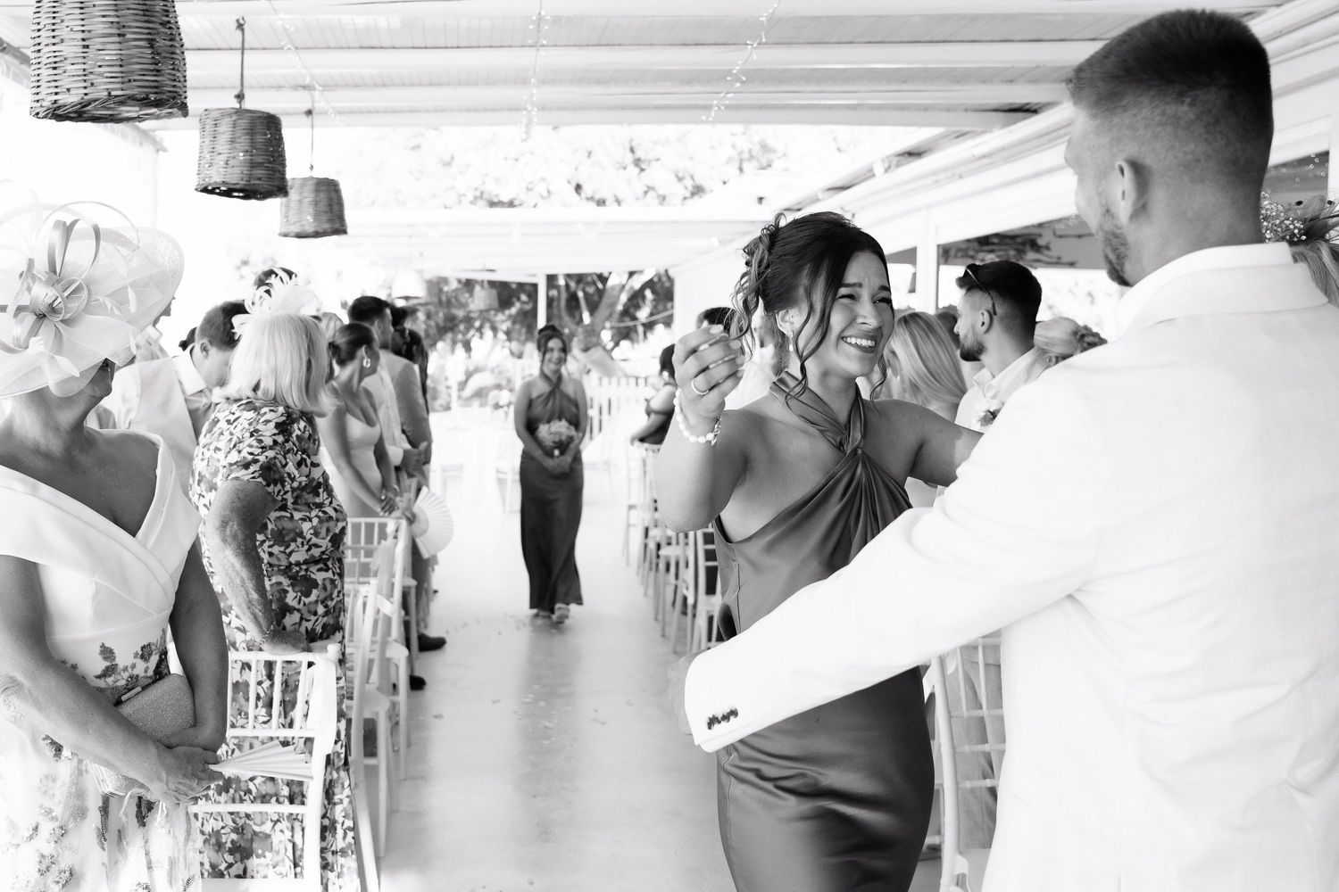 A series of black and white photographs showing people dancing and socializing at what appears to be a wedding reception.