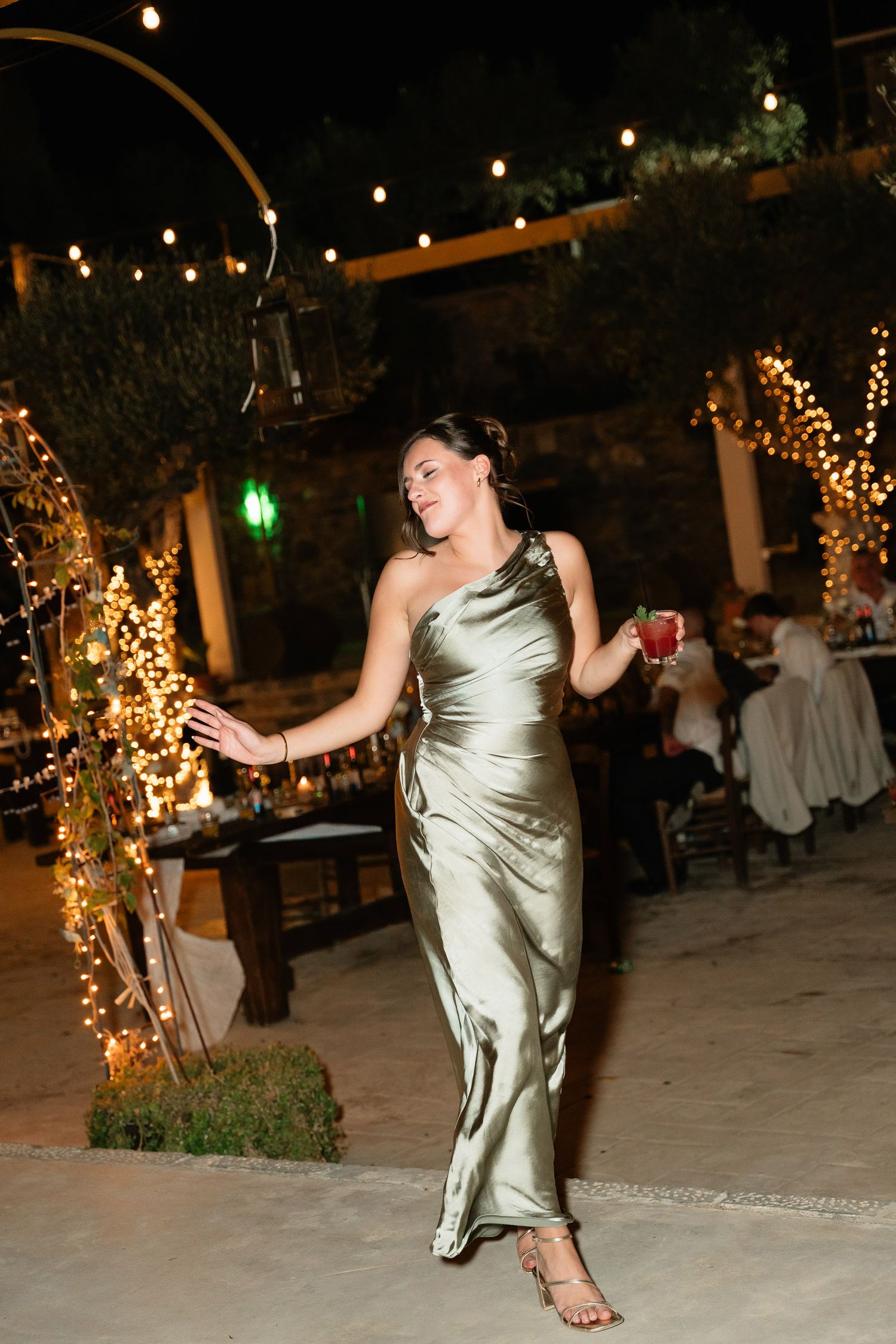 A sequence of photos shows someone in a shimmering gold dress dancing energetically at an outdoor evening reception.