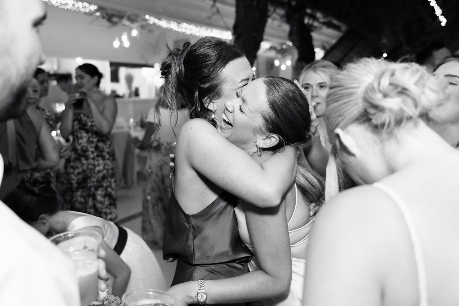 Wedding couples share intimate first dances together at their receptions in a black and white photo collage.