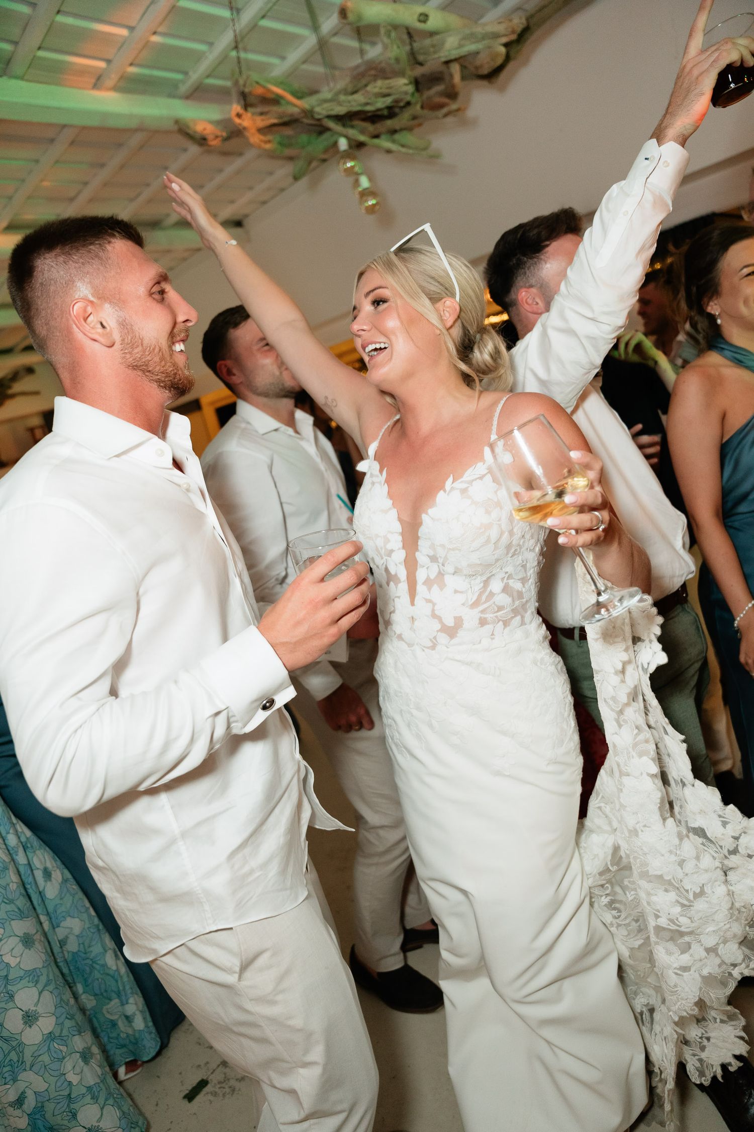 A sequence of wedding reception dance photos showing a couple performing a fun dipping move on the dance floor.