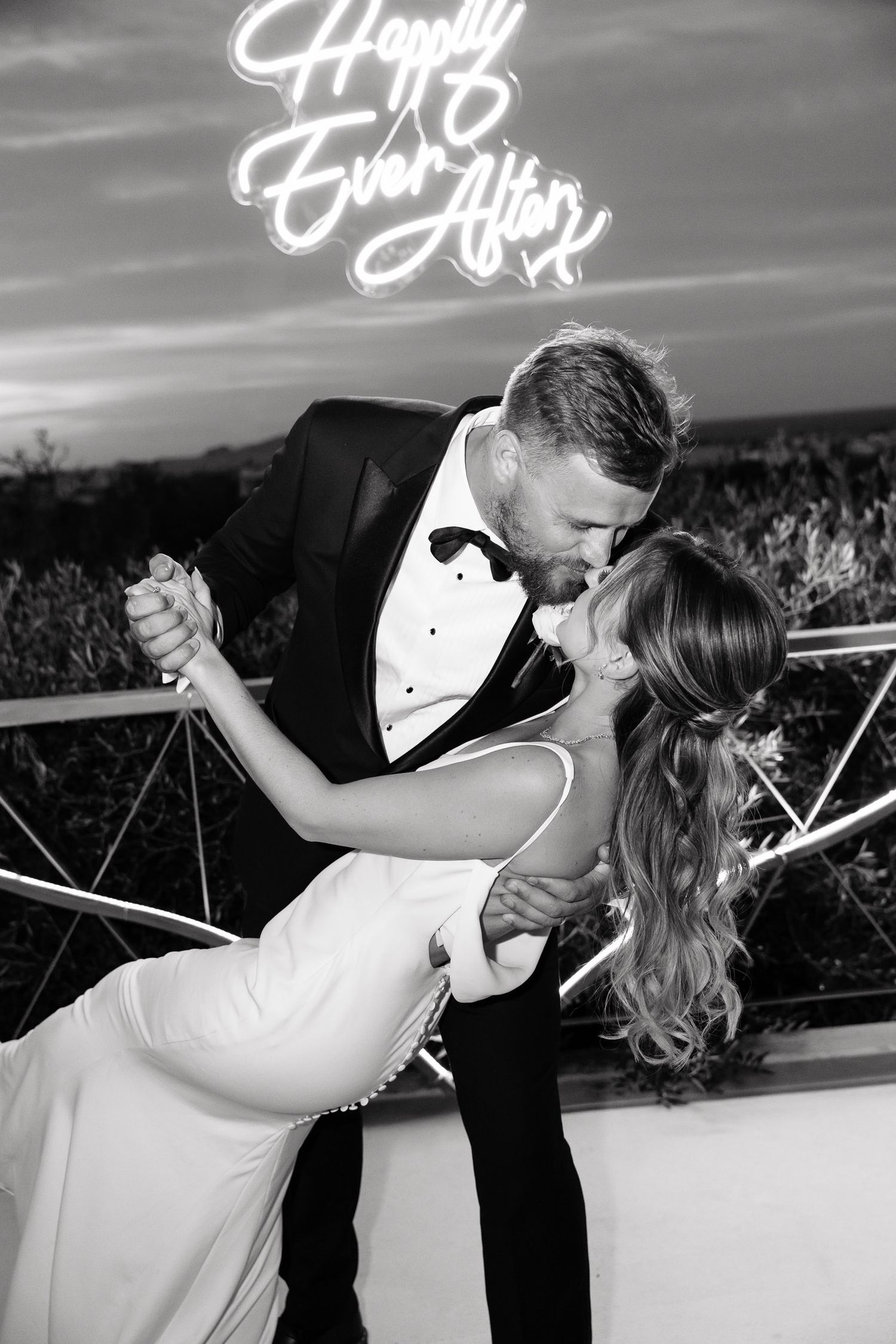 A romantic black and white photo sequence shows a couple dancing and dipping during their wedding celebration.