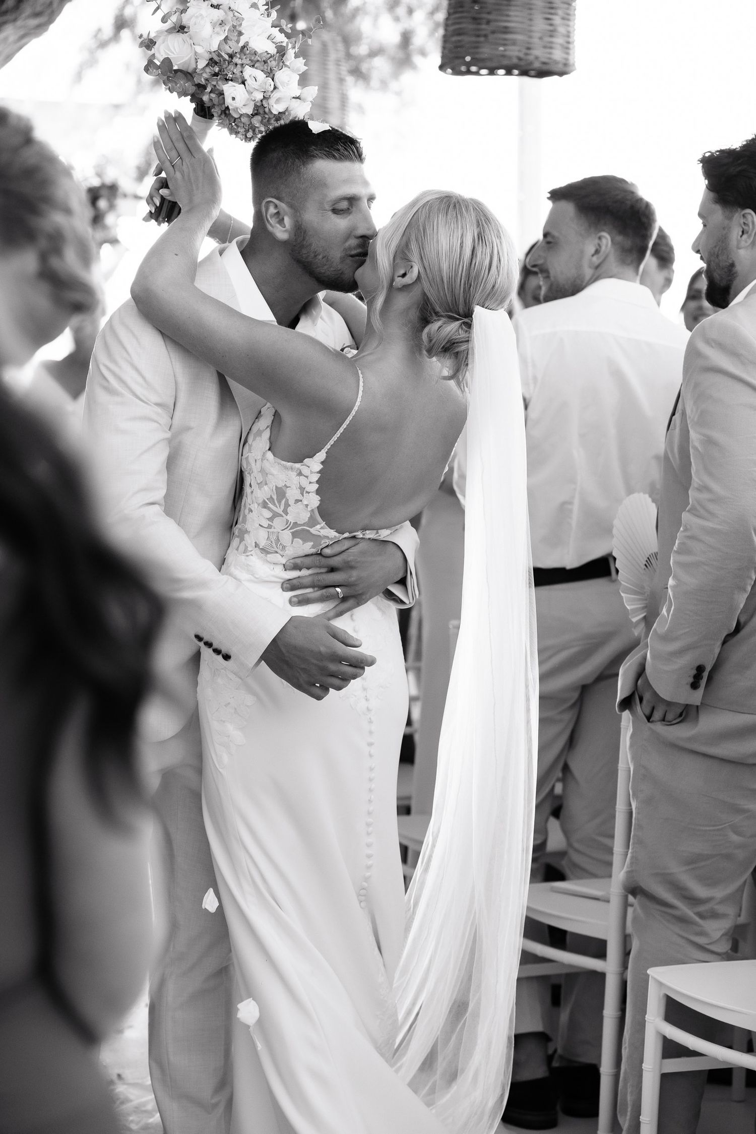 A romantic black and white sequence of a couple dancing together at a wedding reception.