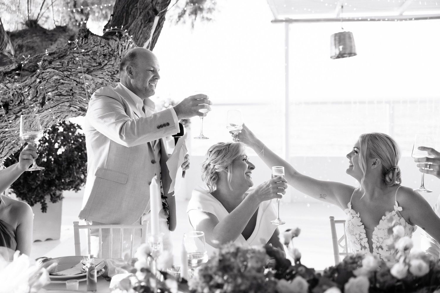 Black and white collage of wedding day moments showing preparation, dancing, and celebration details.