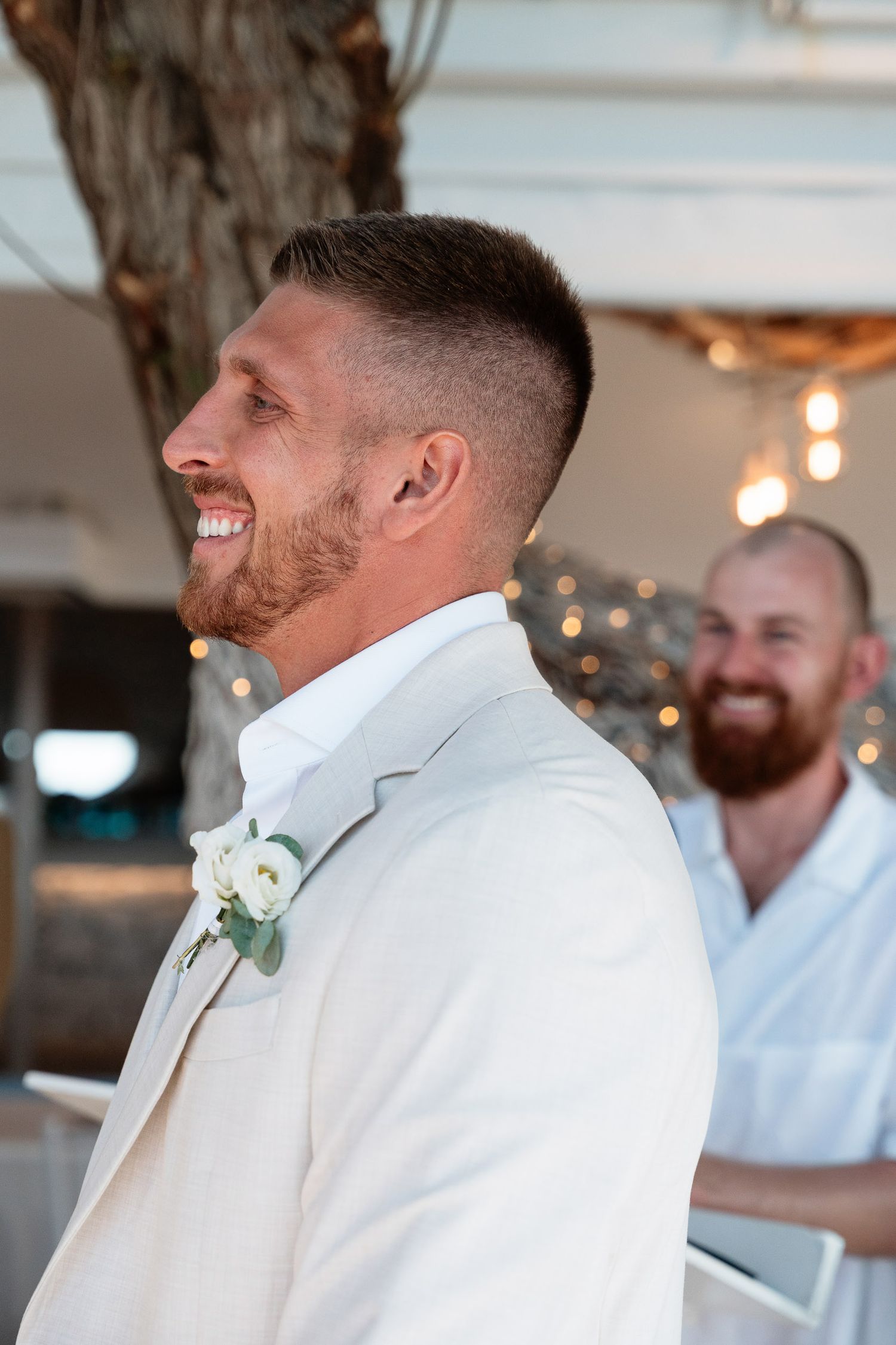 A series of candid wedding photos showing joyful moments between people in white formal attire and boutonnières.