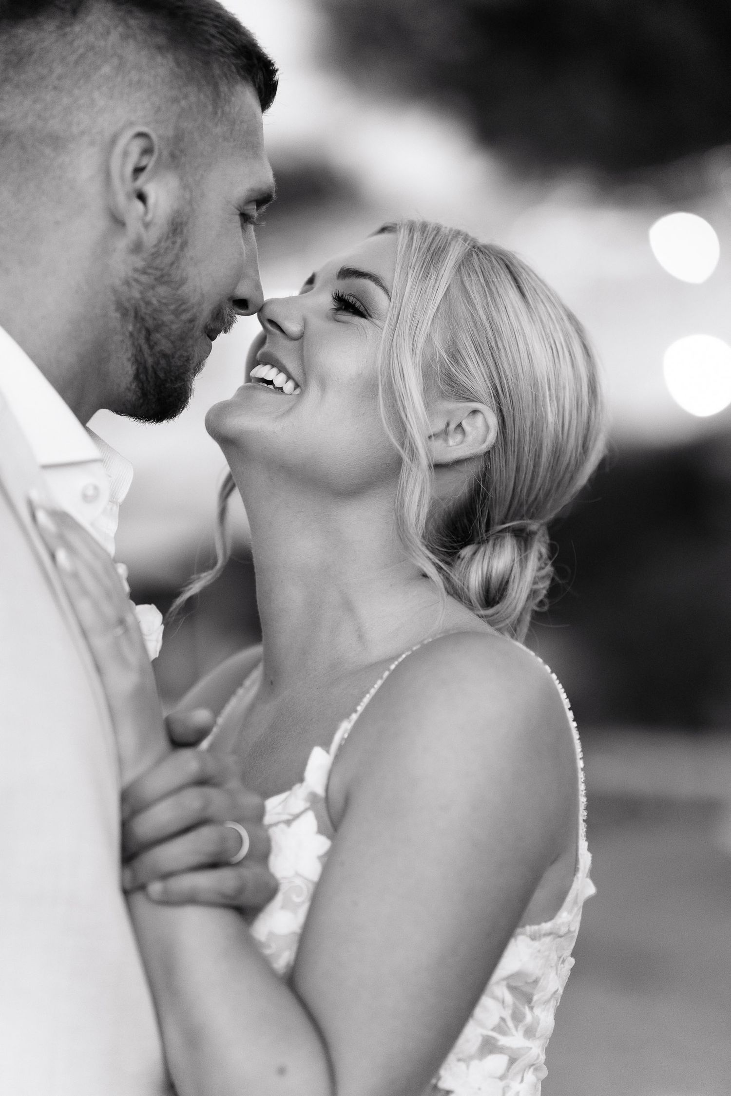 A romantic black and white photo series showing intimate close-up moments between a couple on their wedding day.