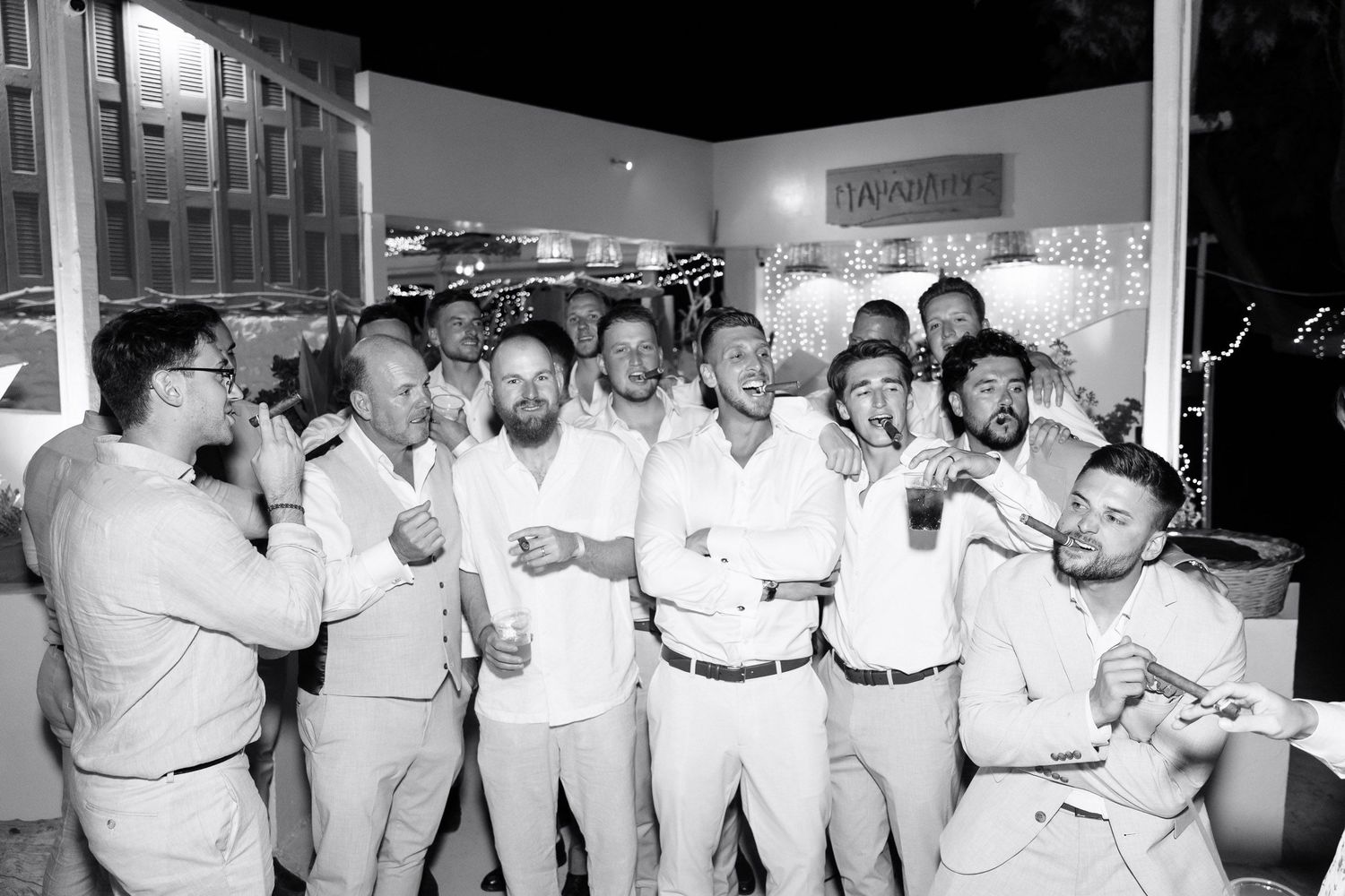 A black and white panoramic photo shows chefs in white uniforms and hats gathered in a restaurant kitchen.