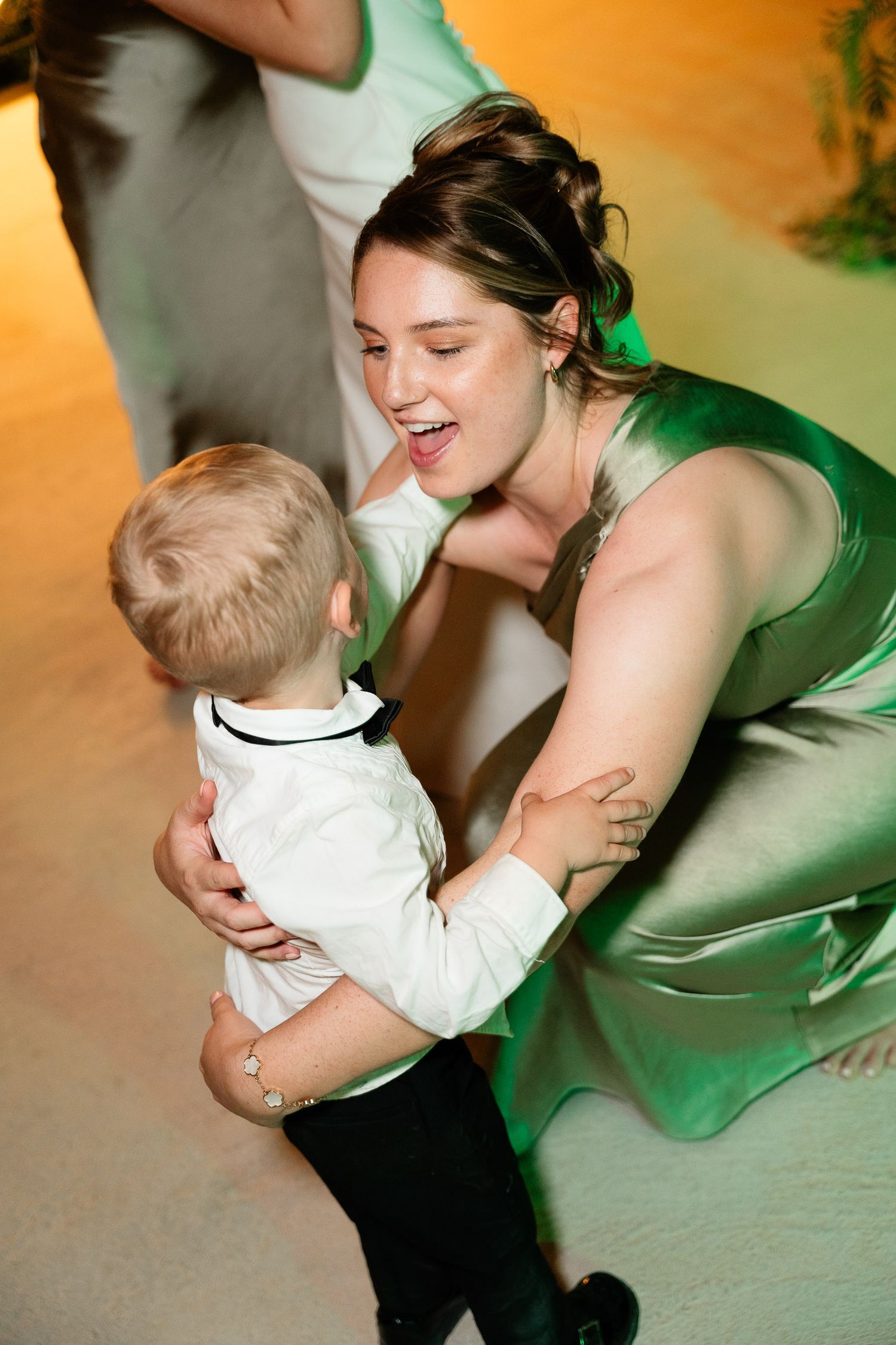 A heartwarming sequence of dance moves between two people in formal attire, with one wearing an emerald green dress.