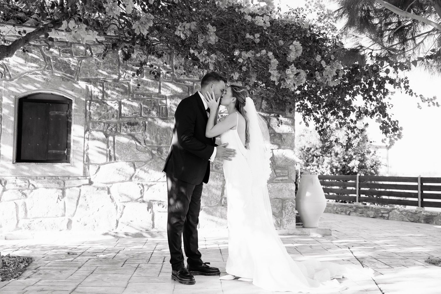 A black and white photo collage showing multiple moments from an outdoor winter wedding ceremony with snow-covered ground.