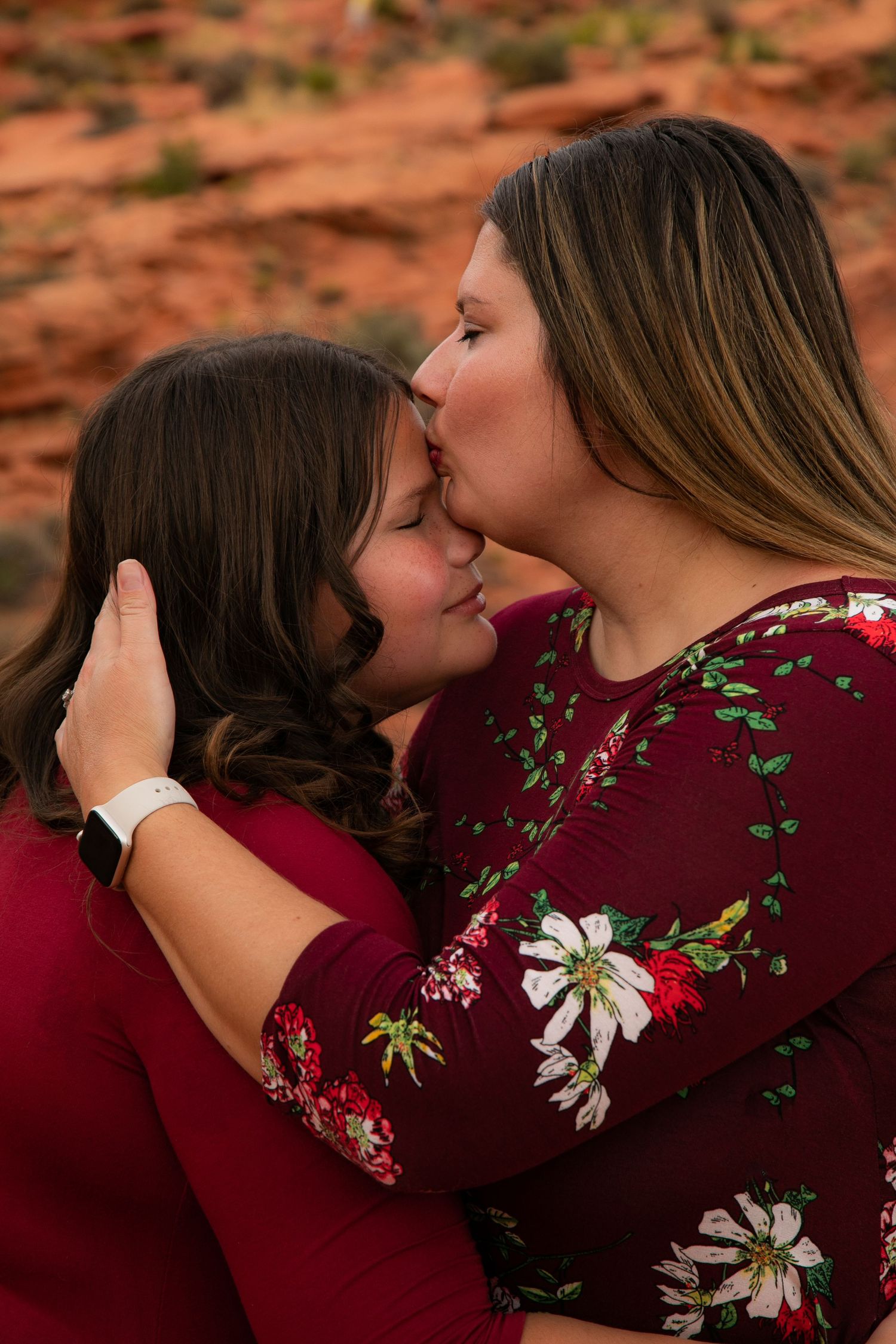 Intimate family moments captured against red rock desert landscape.