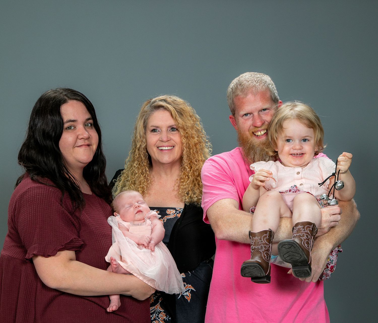 Family portrait series with parents and children posing together against a grey studio backdrop.